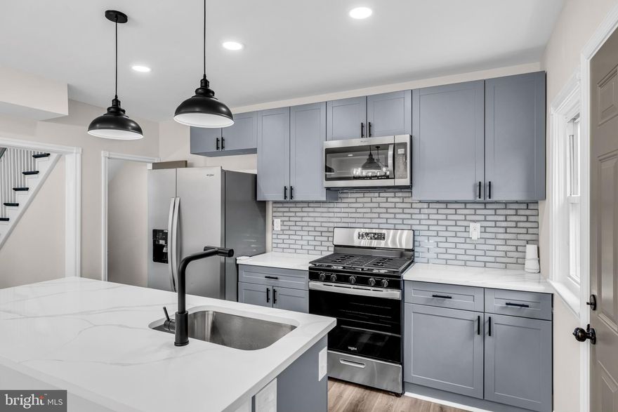 Start your homeownership journey with an incredible opportunity—this home is eligible for the Vacants to Value program, offering up to $10,000 in additional funds toward your purchase!

Welcome to Northwood—one of Baltimore’s most sought-after communities—where charm, space, and thoughtful upgrades come together in this beautifully renovated end-of-group home.

Step inside and immediately feel the difference. This home offers four spacious bedrooms and two full bathrooms, designed with both comfort and functionality in mind. The hardwood floors flow throughout, complemented by fresh, modern finishes and a clean, neutral color palette that allows you to truly make the space your own.

The heart of the home—the kitchen—has been expertly crafted with custom cabinetry, sleek quartz countertops, and stainless steel appliances, creating a perfect space for both everyday living and entertaining. The attention to detail and craftsmanship throughout the home is undeniable.
Enjoy cozy evenings by not just one, but two stunning brick fireplaces, adding warmth and character to both the main living areas and the expansive lower level. The fully finished basement offers a huge additional living space, complete with its own fireplace, a full bathroom, and an extra room—perfect for guests, a home office, or a private retreat.

This home is not just beautiful—it’s solid. Featuring all new mechanical systems, including updated plumbing, HVAC, and electrical, along with a brand-new roof, you can move in with peace of mind.
Outside, enjoy a fenced-in yard, fresh landscaping, and the convenience of a detached garage plus additional parking—a rare find in the city. As an end unit, you’ll appreciate the added privacy and natural light.

Located on a quiet block, yet just minutes from major universities, hospitals, shopping, and downtown Baltimore, this home offers the perfect balance of tranquility and accessibility. With easy access to I-695 and I-83, commuting in and out of the city is seamless.

This is more than just a home—it’s a lifestyle upgrade. Schedule your tour today and take advantage of this incredible opportunity in Northwood!