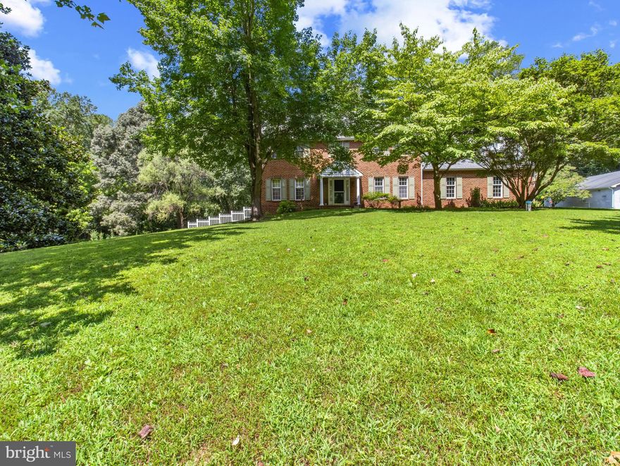 Private 9-acre flag lot with 4BR/2.5BA full-brick home, detached guest house, and 4,000+ sq. ft. shop. Main home offers 3,000+ sq. ft., hardwood floors on main level, updated baths, office, formal dining room, and screened-in sunroom. Upper level includes a primary bedroom with vaulted ceilings and renovated en-suite. Geothermal heating for main home; basement has radiant heated floors. There is a mudroom with an additional toilet. Roof replaced in 2018. Outdoor features include a pool (replastered with new tile/coping in 2021), gazebo, and outdoor shower. A 4,000 sq. ft. shop includes a 12,000-lb lift, heating (mini splits and infrared),AC,  and office/loft. The 1,100 sq. ft. guest house offers 2BR/1BA, laundry, its own septic, and separate meter. All three buildings have separate meters. Property also includes a 24x68 tractor shed. Close to trails; suitable  for horses.