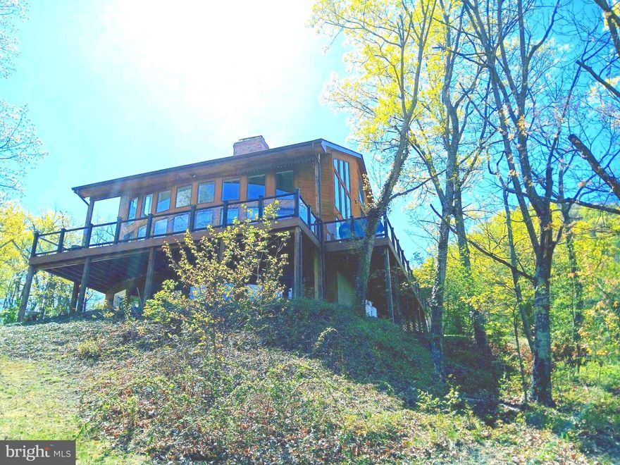 Beautiful home with breathtaking views!!4 bedrooms, and 3.5 baths. Two kitchens! Three levels with approx 4124 square finished footage. 8.23 acres of land to include another on with 13 + acres!!
Open floor plan on the main level. Lower level has the 2nd kitchen! Primary bedroom in the main level. Bonus room upstairs with 2 bedrooms. Lots of sunshine coming thru the windows. Decking around the house. 
A wonderful house to call home. Joins National Forest.