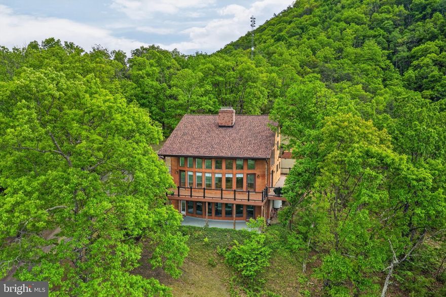 Beautiful home with breathtaking views!!4 bedrooms, and 3.5 baths. Two kitchens! Three levels with approx 4124 square finished footage. 8.23 acres of land to include another on with 13 + acres!!
Open floor plan on the main level. Lower level has the 2nd kitchen! Primary bedroom in the main level. Bonus room upstairs with 2 bedrooms. Lots of sunshine coming thru the windows. Decking around the house. 
A wonderful house to call home. Joins National Forest.