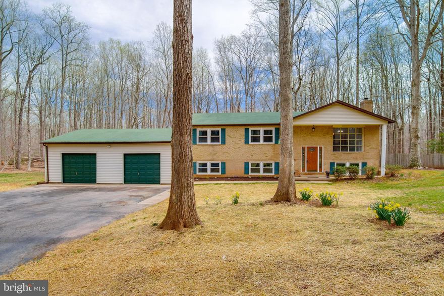 Beautiful 4 bedroom home on private wooded lot with wide plank hardwood floors, country kitchen and a 5.56 acre park like setting!!  Large room sizes throughout. Three bedrooms on main level  and one lower bedroom, along with large bonus room.   Walk out rec room with wood burning stove and full bath.  Cul-de-sac street, perfect for evening walks.   Oversized two car garage, perfect for projects!  LOCATION LOCATION!!   Only 2..5 miles from 234. Easy access to Quantico. Convenient for commuting, VRE or to I 95.   Barn on property sold as is.