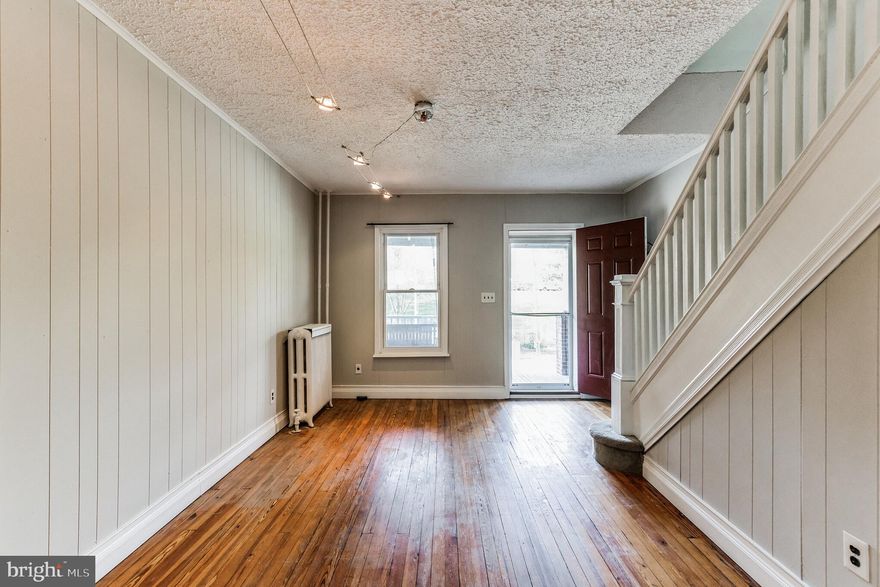 2 BD/1.5 BA Hampden rowhouse with front porch overlooking Roosevelt Park and just steps to the Avenue! Main floor offers an amazing open floor plan with beautiful hardwood floors. 2 BD/1 BA on the second floor including a large primary bedroom with 2 closets, and additional finished space in the basement including a half bath - perfect for office space, studio, play area, gym, or whatever else you want it to be. Kitchen opens up to a patio and fenced yard. Affordable and move-in ready, this has been a great rental property for several years and is ready for your own personal touch! Home is being sold as-is.