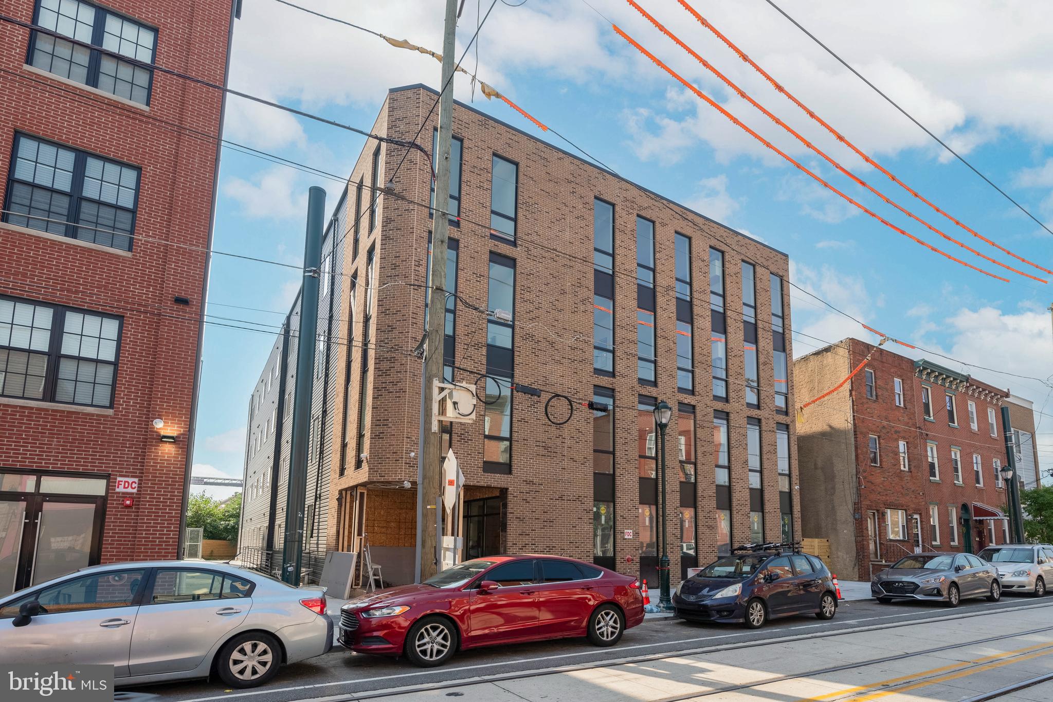 Welcome to Theatre Place, new luxury apartment living located in the Port Richmond area of Philadelphia. This four-story building is composed of 31 tastefully developed residential units - with elevator service to all floors - and offers security, a fitness center, in-unit laundry, optional parking, and more. Residents share access to a roof deck that will offer ancillary space for entertainment and relaxation, complete with unobstructed skyline views. 3037 Richmond Street is pet-friendly and designed to have a clean and minimal look while incorporating unique architectural details to enhance the quality of living. Featuring 1 and 2 BD units, each comes equipped with top-of-the-line selections. Offering a variety of different floor plans, residents have the option to select their optimal, open living standard. Kitchens feature quartz countertops, gleaming stainless steel appliances, white cabinetry, tile backsplashes, decorative pendant lighting, and garbage disposals. Each bathroom is spacious and offers tasteful flooring tile, storage vanities, black Delta fixtures, and stylish mirrors. Select two bedroom units have an additional full bathroom. The building amenities are bar none, offering secure parking spaces, a state-of-the-art fitness center, 24-hour surveillance, and keyless entry. There is ample bike storage. Landscaping by local Apiary Design. The Port Richmond location is in close proximity to public transportation which makes for a quick commute into Center City, University City, and other areas of Philadelphia. Don't miss this chance to live in a brand new, one-of-a-kind building in a neighborhood that offers all the best of Philadelphia! 1 BD units start at $1499/mo. 2 BD units start at $1799mo. Units available starting December 2023. Generally, first, last, and security are due upon move-in. $50 application fee per applicant. Parking available on a first-come, first-serve basis. $45 flat water fee/mo. Some photos may be of a similar staged unit.