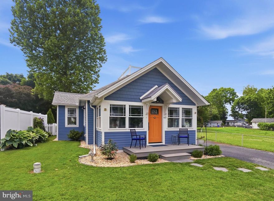 Renovated in 2021. -  Quality construction and materials throughout! Enjoy the open floor plan yet cozy cottage filled with natural light, the screened porch, deck overlooking the beautifully manicured and landscaped back yard, an updated guest cottage /studio with an additional bedroom and full bathroom, a rooftop observation deck, community area with large sandy beach and dock. Main house is approximately 1122 square feet plus the screened porch and the cottage is approximately 280 square feet.   A must see to appreciate all of its's charm and character.