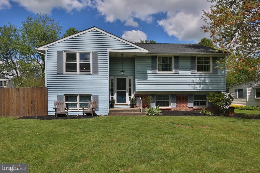 Welcome to 230 Hillcrest Drive in Doylestown Borough and the established neighborhood of Sandy Ridge Acres! This well maintained home, with many upgrades throughout, features 4 Bedrooms and 2 full bathrooms. The entry foyer leads you upstairs to stunning hardwood floors throughout the main level. You'll find a spacious living area with a dining room and an open concept kitchen.  The upgraded kitchen features black and stainless appliances, white cabinets, granite countertops, and tile backsplash.  The kitchen also features a breakfast bar.  The glass patio door leads to a gigantic raised deck with enough space  for all your entertaining.  The backyard is spacious, flat and fully fenced.  The main level of the home also features a spacious primary bedroom with a glass patio door that leads to the deck, two additional bedrooms and a full bath with tub shower.  The lower level has been updated and features a bedroom or office with new carpets.  The spacious additional family room on this level has a gas fireplace, wainscoting, a glass patio door that leads to the backyard.  The lower level also includes a new full bathroom with a standing shower.  This home also includes a storage shed with electric, one car garage and spacious off street parking in the driveway.  There's a short walk to shopping, restaurants, and Doylestown's Main Street for an ideal location!