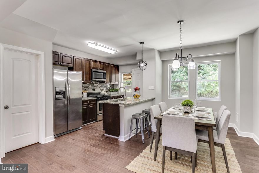 Beautifully Renovated Home  with Off Street Parking in Rear. Open Concept Floor-plan with Trayed Ceilings. Granite Counter Tops, Center Island with Pendant Lighting, Dishwasher and Deep Sink.  Newer Hardwood Flooring, Windows,  Appliances, Central HVAC and Water Heater.  Finished Basement with Office. Two Full Updated Bathrooms with Ceramic Tile. Lots of Recessed Lighting on the Main Level and Basement. Basement access from rear door and from Main Level Inside. All New Carpet. 3 Well Lit Bedrooms on Upper Level. Fresh Paint Throughout.