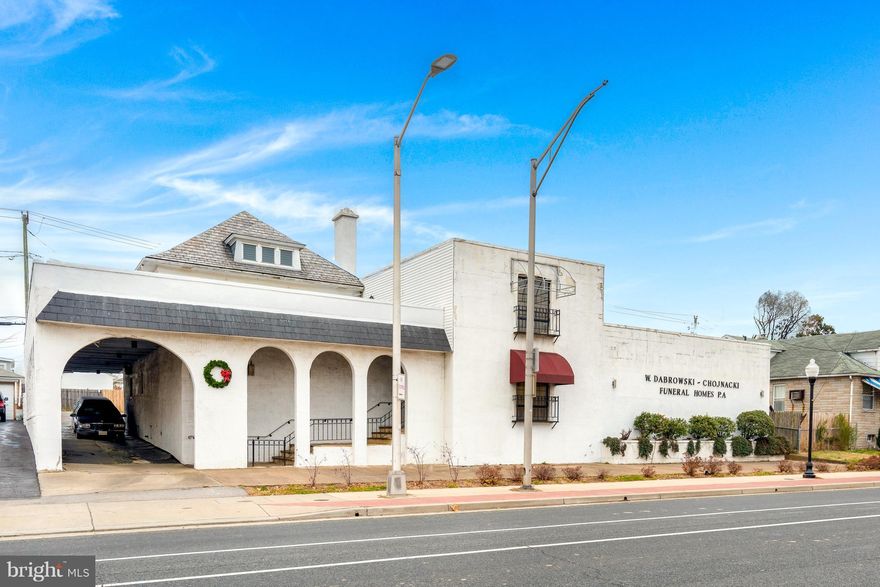 Large commercial building currently used as a Funeral Home. Building entrance is ground level with 6 large rooms on the main level. 2 large offices on the main floor and 1 private office. Private office bathroom. Lower level offers large lounge/coffee room , 2 multi stall bathrooms, embalming room, and a large display room.  Equipment conveys with sale. (list can be furnished upon request)Second level contains a full size 3 bedroom apartment with 2 full baths. Large kitchen with separate dining area, large living room, and attic space. Also has a 2nd level patio off of the kitchen. Parking access from O'donnell St., Dundalk Ave. and/or Bushey St. 30+ parking spaces. Contact Listing Agent For Private Showing.