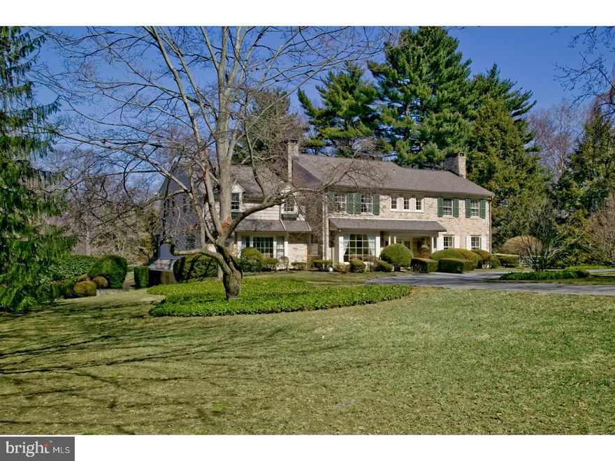 Rare offering in exclusive, highly desirable Pembroke Estates! A stately stone exterior & magical environs beautified by lush landscaping & privatized by mature trees make 400 Garden Lane a true gem. Hidden away from it all but convenient to amenities, the home is nestled on 1.39 breathtaking acres in the area's most special neighborhood. This impressive 2-story Colonial sits on a very quiet, low-traffic street yet enjoys the company of friendly neighbors. Enjoy a world all your own, with walkability to the town & train! Recent updates include replastering/repainting the swimming pool, installing new pool equipment & painting the house inside & out. A circular drive welcomes your arrival & a flagstone walk leads to the covered main entry. A vestibule with brick flooring, coat closet & powder room proceeds to the gracious foyer with hardwood floors. A large opening accesses the spacious living room with a black granite fireplace & glass-paneled door to the flagstone terrace/pool, perfect for entertaining. Fine woodwork, finishes & architectural elements along with generous natural light grace all generously-sized rooms. The dining room adorned with moldings overlooks the rear grounds & spills out to the terrace. The cook can get creative in the gourmet center island kitchen styled with Wood Mode cabinetry, granite countertops & premium stainless steel appliances. Enjoy coffee in the adjacent vaulted breakfast room with dual skylights & a wall of windows facing the rear oasis. A library with built-ins & corner fireplace of richly paneled millwork showcases picturesque views. Gather in the light-bathed family room with a own glass door to the rear, striking ceiling beams, built-ins, V-groove paneling detailing & marble-surround fireplace. A laundry room, walk-in pantry & full bath optimize this level.Retire to your peaceful vaulted master suite occupying its own wing on the 2nd floor, with 2 walk-in closets & a renovated Carrera marble bath presenting a frameless glass shower & Whirlpool tub. Four more BRs, a vaulted sitting room & 2 full baths complete the comfort. Stairs rise to an unfinished attic for storage. The day-lit lower level with a recreation room, home theater, powder room & bonus room can be entered from the foyer & 2-car garage. Everyone will love playing on the front lawn around the huge pine tree or private rear property that makes living here incomparable.