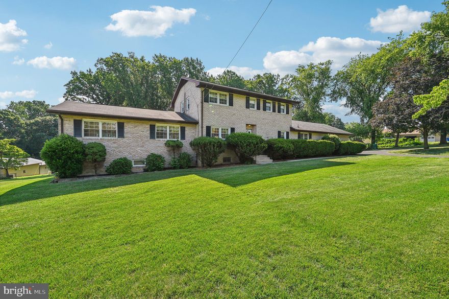 Unbelievable opportunity to own a great house in a great location.  Situated on 1.72 tranquil acres, in a great school district, less than a half a mile from the city limits.  This brick two-story checks many homebuyer boxes.  Three finished levels, with main level owner's suite.  Offering 4 BRs, with three full and two half baths, this well designed home backs up to the Long Branch Creek and offers plenty of sanctuary space and opportunities to relax.  Lower level recreation room with bar, and den, plenty of storage space.  Two gas fireplaces (one on main level, one in rec room), main level laundry in breezeway.  Oak hardwood flooring under the carpeting in the LR, stairs to upper level and all of the upper level BRs.  Great east facing deck overlooking  the inground pool.  This property is close to commuter routes, shopping, dining, schools, employment opportunities, medical facilities, places of worship and recreational pursuits.   No City Taxes and no HOA.