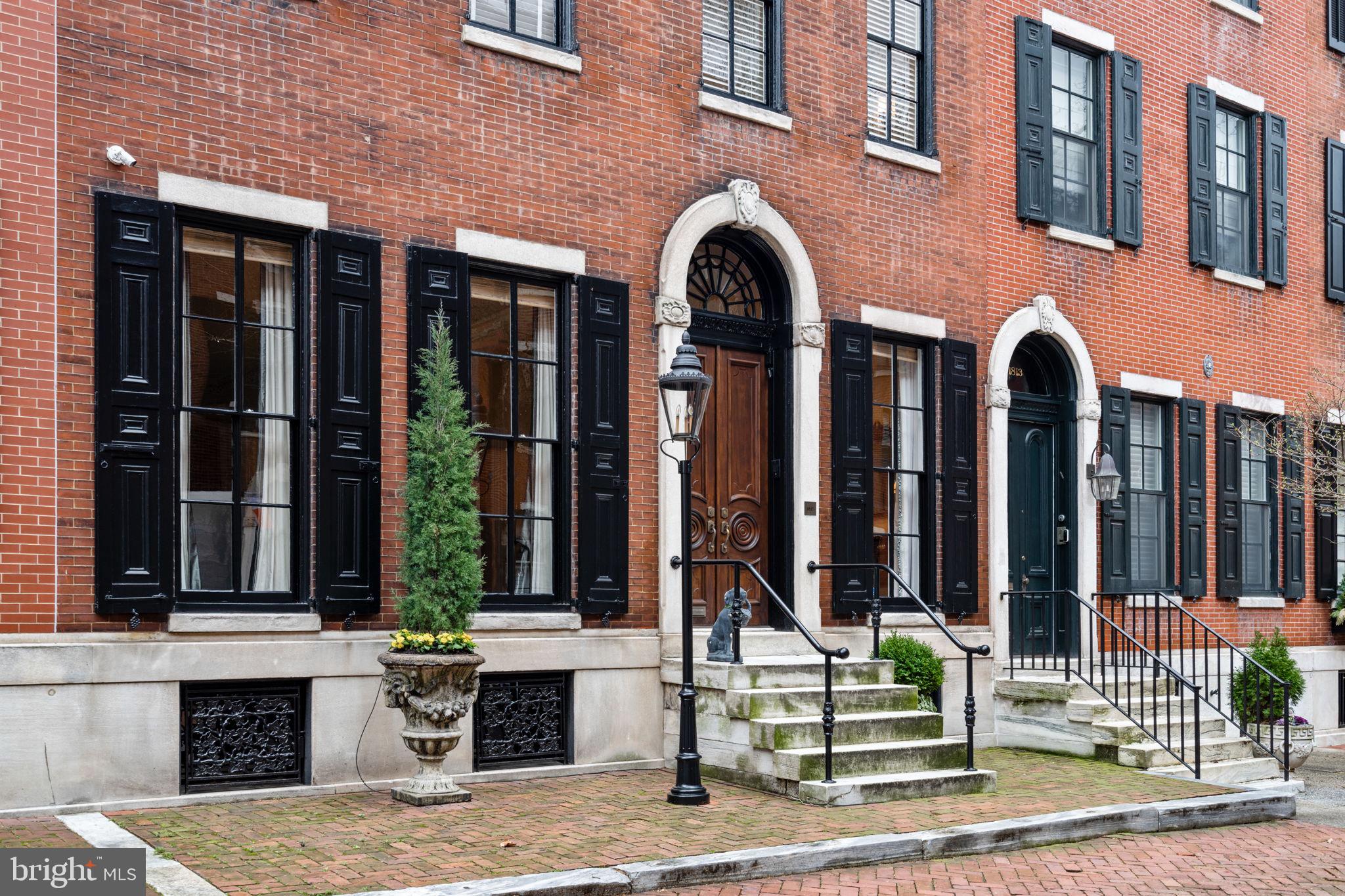 Situated on one of the most coveted blocks in Philadelphia, this remarkable four-story townhouse
spans an impressive 29 feet in width and has undergone meticulous refurbishments to create the
ultimate space for elegant entertainment and family living. Originally constructed in 1857 by Samuel
Spackman, this 5500 square foot Federal style home blends original ceiling moldings and design
elements with contemporary luxuries. The L-shaped home has been renovated around an exquisite
outdoor brick garden with a fountain, gas grill, and exterior doors which function as a service entrance
for deliveries and landscapers.
Carved mahogany entry doors open onto a classic foyer with marble floors and a striking, curved
staircase. The expansive living room boasts high ceilings, oversized windows, intricate moldings and
an original marble fireplace mantel converted to gas. The sizable dining room, with a high ceiling,
intricate moldings and a gas fireplace, can accommodate large dinner parties.
Moving toward the rear of the residence, one’s eye is drawn to a classic chef’s kitchen with coffered
ceilings custom-designed by Arthur Works and oversized windows looking onto the garden. The
centerpiece is the large Statuary marble island and the kitchen is equipped with top-of-the-line
appliances including two Miele dishwashers, Wolf range top, two ovens, a warming drawer, and
microwave and convection oven. A separate breakfast area with views of the landscaped garden
provides a seamless connection between indoor and outdoor living. Back stairs from the kitchen to
the second floor entertainment area enables a wonderful flow for parties and family living.
The second floor hosts a guest bedroom suite with en-suite bathroom (with radiant flooring), a home
theater/media room, a cozy library with custom shelving, and a game room featuring a wet bar, and
gas fireplace.
The third level reveals a luxurious Primary bedroom suite complete with his and her dressing rooms
with built-in closets and natural light. The large primary bathroom includes radiant flooring, a large tub
with air jets, an oversized shower, a heated towel rack, commode, and washer dryer. The elevator
landing on this floor leads to an outdoor area with plumbing for irrigation in place for additional
outdoor deck possibilities.
The fourth level comprises three additional bedrooms, serviced by a full hall bathroom (with radiant
flooring).
The lower level offers a playroom, laundry room, storage areas, mechanical room, cedar closet, and
access to the oversized one-car garage. The custom 5-stop elevator designed with quartersawn oak
runs from the garden level to the fourth floor.
The proximity to Rittenhouse Square Park and a variety of excellent stores, restaurants, museums
and entertainment options enhance the allure of this distinguished residence.