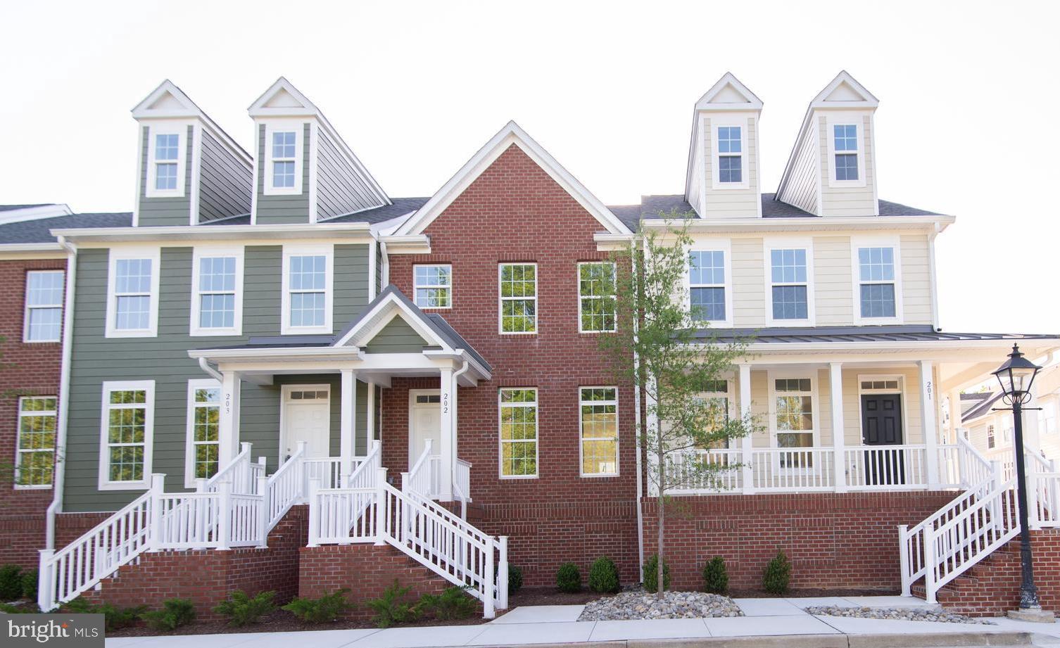 This thoughtfully designed interior townhome at 300 Dixon Street offers modern, efficient living in a distinctive four-level layout. The exterior features an attractive brick front complemented by Hardie Plank siding on the rear, creating a unique blend of textures that sets this unit apart. A brick stairwell at the front leads to a covered porch at the entry, providing a welcoming first impression.
Level 1 – Garage & Service:
The ground level features a private garage with rear entry and direct access. This level also includes a half bath, a versatile bonus room, a dedicated laundry room, and a utility closet—providing functional living and ample storage.
Level 2 – Main Living Area:
Step through the welcoming foyer into an open-concept space that integrates the living room, a well-appointed kitchen, and an eat-in dining area. The kitchen is equipped with GE stainless steel appliances (cooktop, double wall oven, hood vent, dishwasher, refrigerator, and garbage disposal), stone countertops, and custom Timberlake cabinetry. Sliding glass doors open onto a balcony that enhances the space, while a conveniently located half bath, coat closet, and pantry add everyday practicality. High ceilings and crown molding complete the inviting atmosphere of this level.
Level 3 – Bedrooms & Full Bathrooms:
This level offers three comfortable bedrooms and two full bathrooms designed for everyday living. Both full baths have been upgraded with quality Moen fixtures, tile floors, stone countertops, and custom Timberlake cabinetry with white subway tile accents in the showers. The primary bedroom suite features a generous walk-in closet and an expansive primary bathroom with a dual vanity and extra storage closets for toiletries and linens. Plush carpeting throughout the bedrooms and hallways adds warmth and comfort.
Level 4 – Loft:
The flexible loft is equipped with its own mini split unit for heating and air conditioning and features two skylights to supplement natural light. This adaptable space is ideal for a home office, playroom, or additional living area, offering versatility to suit your lifestyle.
Residents of Unit 202 will enjoy low-maintenance living within Dixon Square, enhanced by brick stairways, well-kept sidewalks, and beautifully landscaped grounds maintained by the HOA. Located in vibrant Talbot County at the heart of Maryland’s Eastern Shore, this home provides effortless living with access to outdoor adventures, cultural experiences, and a diverse mix of locally owned dining options.