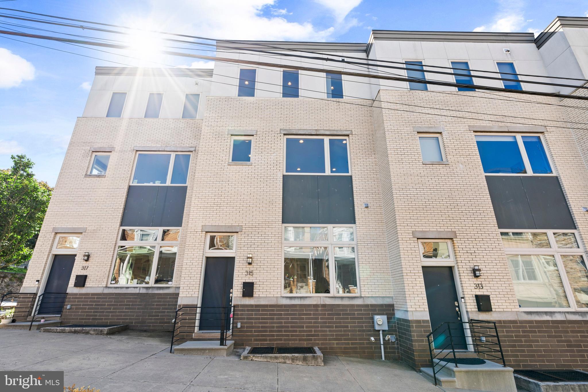 Welcome to 315 Dupont Street, a stunning 20 foot wide lot home in the heart of Manayunk! This beautiful home boasts 3 bedrooms, 3.5 bathrooms, and a generous 2,400 square feet of living space. Step inside the main level and be greeted by hardwood floors, recessed lighting throughout, and a cozy bedroom with bathroom perfect for guests or in-laws. Then make your way to the 2nd floor, you’ll be greeted by vaulted, double height ceilings in the living area with floor to ceiling windows allowing tons of natural light! The kitchen features stainless steel appliances, granite countertops, tile backsplash, tons of cabinets for storage, and a large island perfect for barstool seating. Upstairs, you’ll find 2 spacious bedrooms with custom closet organizers with en-suite bathrooms. The finished basement has a dedicated laundry area, and adds versatility to the property providing additional space for recreation. This home also has 2 car attached garage parking spaces. In close proximity to all of the restaurants, bars, grocery stores, parks, and coffee shops that Manayunk has to offer, this home is in a perfect location. Schedule your showing today!
