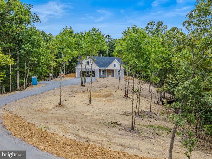 New Construction in Gerrardstown, WV – Delivery September/October 2025. Experience the perfect blend of style, comfort, and privacy in this stunning single-level home with a spacious bonus room above the garage, situated on a 5.32-acre wooded lot offering peace, space, and seasonal mountain views. Located just 23 miles from Winchester, VA, this property combines a serene retreat with excellent commuter convenience.Featuring 3 bedrooms and 2.5 bathrooms, this home is thoughtfully designed with upscale interior finishes throughout. The fireplace with a floor-to-ceiling tongue-and-groove focal wall adds warmth and elegance to the main living area, while the covered rear patio is perfect for enjoying nature year-round. The bonus room above the garage offers endless possibilities—ideal for a home office, hobby space, or guest area. With modern craftsmanship, energy-efficient design, and a beautiful natural setting, this home delivers the ultimate in comfort and function.