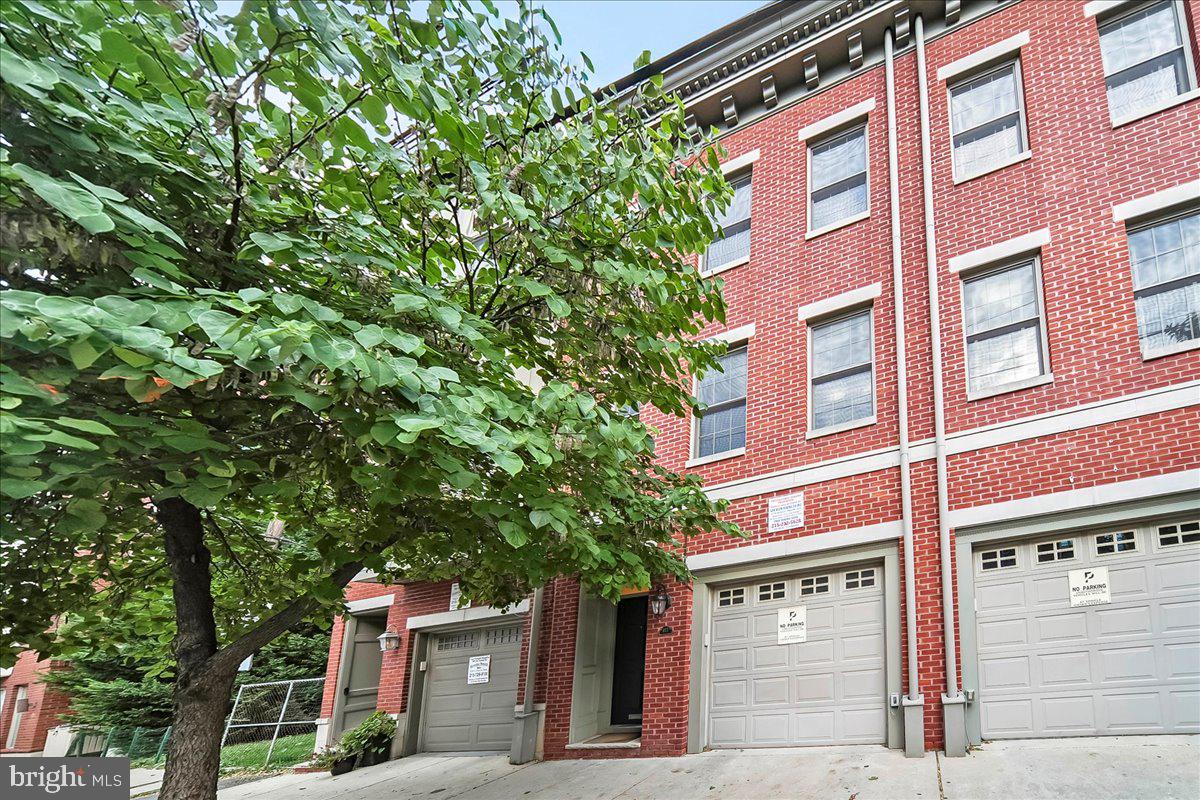 Move right in to this like-new four-bedroom brick townhouse featuring a convenient split-level layout, three full en-suite bedrooms, wonderful outdoor space, and garage parking in Philadelphia’s desirable Fairmount neighborhood. Inside this 3,073-square-foot brick home, tall ceilings dotted with recessed lighting rise above crisp white art-walls and beautiful hardwood flooring. A tile vestibule with French doors makes a warm welcome. Above the open-plan main level offers an ideal layout for entertaining with a large living room, dining area and a gourmet kitchen lined with abundant cherry cabinetry and granite countertops and backsplashes. Chefs will love the upscale stainless steel appliances, including a new Samsung vented range and French door refrigerator, plus a dishwasher and built-in microwave. A powder room and extra-large laundry room/utility room add convenience within easy reach of the gorgeous main floor. Meanwhile, the home’s walkout lower level — a Philadelphia rarity — delivers a generous footprint for a family room, home gym, office, or all of the above, with a second powder room and additional refrigerator. Accessible from both the living room and lower level, the home’s private patio is an irresistible destination for outdoor lounging and entertaining. Head upstairs to explore the luxurious primary suite featuring a king-size bedroom with huge windows, two walk-in closets, and ample linen storage. The en suite spa bath beckons with a jetted soaking tub, frameless glass shower, vanity and designer tile. Two oversized secondary suites boast en suite baths and abundant closet space. A fourth bedroom, perfect as a guest room or home office, completes this expansive layout. Built in 2008, this home offers extensive upgrades, including Nest thermostats, keypad door locks, fresh paint and stain inside and out, a newly coated roof, a new water heater, and an updated HVAC blower. An attached front-facing garage with a new smart garage door opener adds easy off-street parking to this turnkey Philadelphia showplace. CMX4 zoned for a home office option. Located in Fairmount’s Spring Garden section, this home offers excellent walk, transit and bike scores with fantastic attractions and amenities just minutes from your door. The nearby blocks are lined with outstanding restaurants, nightlife destinations, museums, and abundant supermarkets, including Aldi, Giant, Whole Foods, and coming-soon Lidl. Enjoy the Francisville Pool and Playground, Spring Gardens, Roberto Clemente Playground, gorgeous Schuylkill River waterfront, and Center City attractions. This welcoming enclave also provides donation-funded street sweeping, resident permit-only parking, and a neighborhood listserv. Transportation is effortless with the Fairmount subway station, SEPTA Route 15 trolley, excellent bus service, and multiple highways all nearby.
