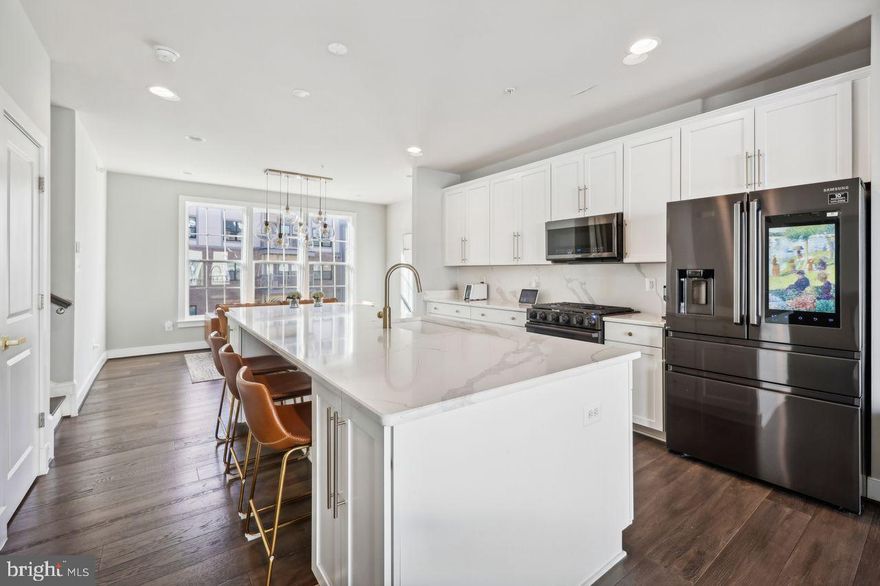 BACK ON THE MARKET - Gorgeous 4-level luxury town home awaits its new owner! This meticulously kept 3 bedroom, 3.5 bath home features 9 ft ceilings, open-concept main level with gourmet kitchen. Kitchen boasts an expansive center island with upgraded Samsung Smart appliances and modern fixtures. Enjoy the light filled spacious living room with balcony. The upper level includes the primary bedroom with en suite including glass shower enclosure, large closet. Two additional bedrooms, full bathroom and laundry complete this floor. The Fourth floor features a spacious flex room including a full bathroom. It adjoins to the rooftop terrace that features an upgraded retractable awning, which is excellent for entertaining. This home also boasts a 2-car garage with electric vehicle charging. Minutes to the beltway and steps away from the metro.