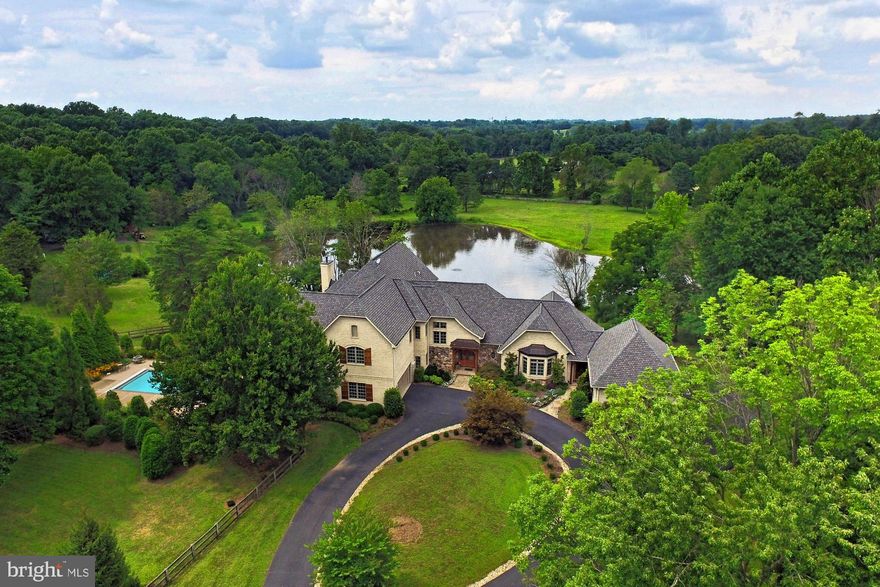 Gorgeous French Colonial Estate with Lake views.  This home is close to all the amenities with that private retreat feel.  Custom home on 5 acres in Clifton.