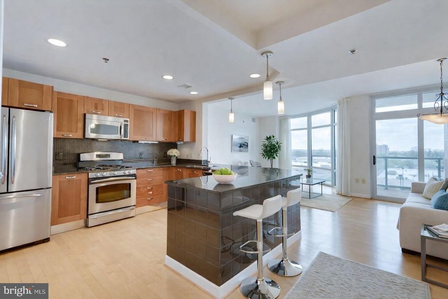 Welcome to this spacious 2 bedroom, 2 bath corner unit in the sought-after Midtown Bethesda North Condominiums, offering over 1,400 square feet of well-designed living space. Hardwood floors run throughout the main living areas, complemented by floor-to-ceiling windows that bring in abundant natural light. As a corner unit, the home enjoys added privacy and a larger balcony.

The open layout features a generous kitchen with stainless steel appliances, granite countertops, gas cooking, and ample cabinetry, along with a built-in dry bar ideal for entertaining. Custom shelving and thoughtfully designed storage areas are found throughout the unit, adding both function and convenience.

The primary bedroom includes a custom walk-in closet and an en-suite bath with dual vanities and a jetted shower. A new washer and dryer are located in-unit. One over-sized assigned parking space conveys.

Midtown Bethesda North offers a full suite of amenities, including concierge service, fitness center, rooftop pool, theater room, lounge areas, and more. Gas and water are included in the condo fee. Conveniently located near major access points, shopping, and a wide variety of restaurants.