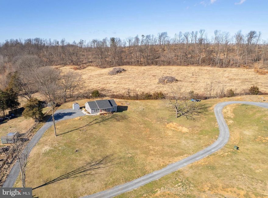 Like-new 3-bedroom, 2-bath rancher built in 2024, set on 1.4 acres with beautiful mountain views. Laminate plank flooring runs throughout the home, complementing the open-concept kitchen, living, and dining area—perfect for everyday living and entertaining. The kitchen features granite countertops, a center island with seating, stainless steel appliances, electric cooking, and a pantry. The primary suite includes a private bath with granite countertops and a tub shower. Enjoy outdoor living on the covered front porch or the rear deck, all while taking in the peaceful surroundings and scenic mountain views. Check out our 3-D tour attached to this listing!