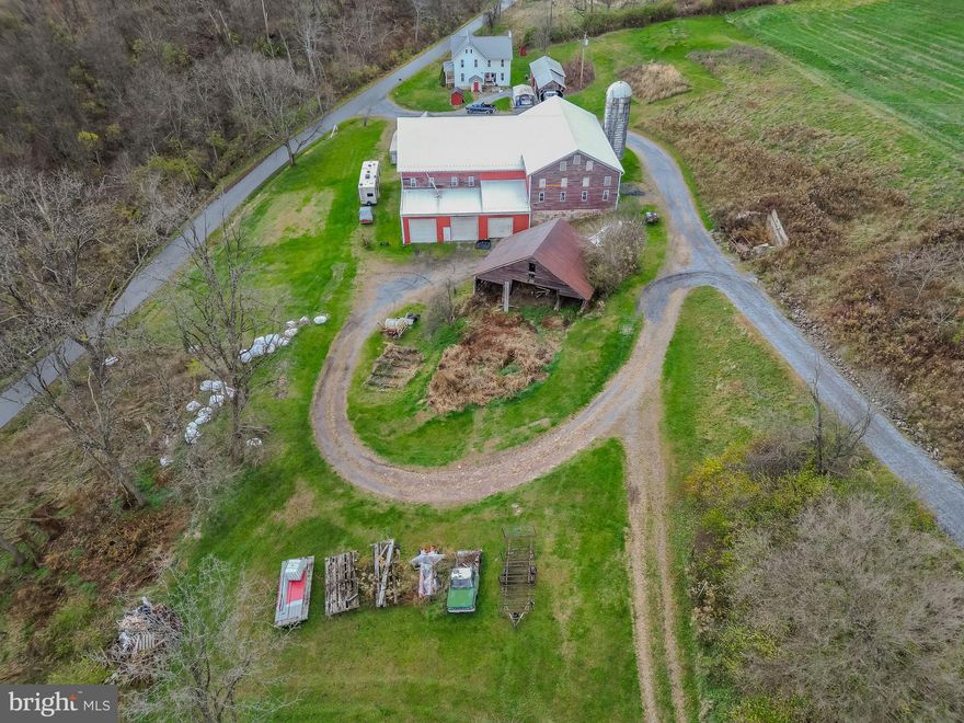 32.4 acres with a 4-bedroom, 2-bath farmhouse, a pig nursey barn, a bank barn, and other outbuildings in Clinton County. Property has a mix of woodland and tillable with a small stream and is in a secluded location. The pig nursery facility is 100' x 300' and can hold 4800 feeder pigs. Each room has its own heat, water, feed, ventilation and monitoring system and hose hookups for the barn's hot water pressure washer system. There are 4, 15-ton feed bins on site as well as a permanent diesel backup generator with an automatic transfer switch system and 2, farm-owned 1000-gallon propane tanks. Good contract available. Great opportunity for someone who wants to run their own business at home.