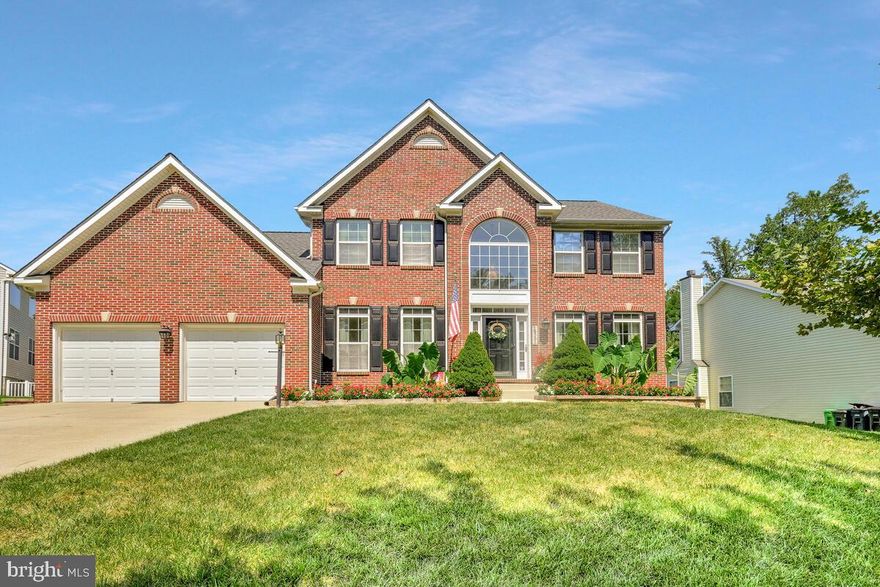 Welcome to this beautifully maintained brick front colonial, featuring a two-car garage and a thoughtfully designed layout that combines comfort, style, and functionality. From the moment you step inside, you'll appreciate the attention to detail and high-end finishes throughout. The main level boasts gleaming hardwood floors and a grand staircase, along with a versatile den/study enclosed by elegant French doors—perfect for a home office or reading nook. The formal living room showcases crown molding and soaring 9-foot ceilings, while the formal dining room is highlighted by crown molding and chair rail, ideal for hosting dinner parties and special occasions. The gourmet kitchen is a true standout, featuring quartz countertops, a ceramic tile backsplash, an island with built-in electric cooktop, and 42-inch cabinets offering ample storage. Adjacent to the kitchen, the bright and airy morning room provides the perfect spot for casual dining. A convenient main-level laundry room and powder room complete this level. Upstairs, the luxurious primary suite offers vaulted ceilings, a spacious walk-in closet, and a spa-like ensuite bath with double vanity, soaking tub, and separate shower. Three additional generously sized bedrooms and a full hall bath provide plenty of room for family and guests. The fully finished basement adds even more living space with a large recreation room, full bathroom with tub, a utility room, and a versatile flex space that can be used as a bonus bedroom, gym, or media room. Ideally located just minutes from restaurants, shopping, and major highways, this home truly has it all. Don’t miss out—schedule your private tour today! This one won’t last long!