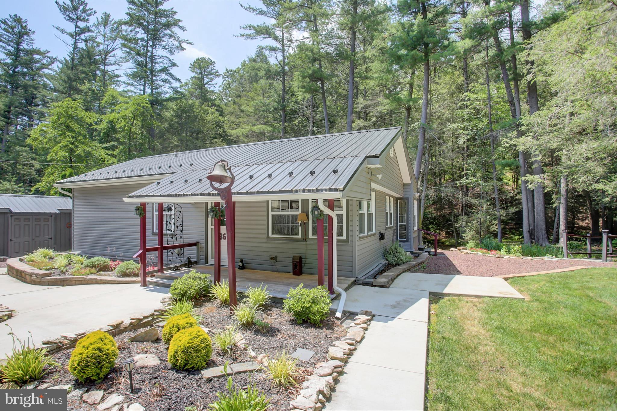 Beautifully landscaped property on 1 acre leased land. This is not state land; therefore, year-round living is permitted. Also, the sale is not limited to PA residents. This would make a great getaway or permanent residence, beside a babbling brook among the trees. Move-in ready