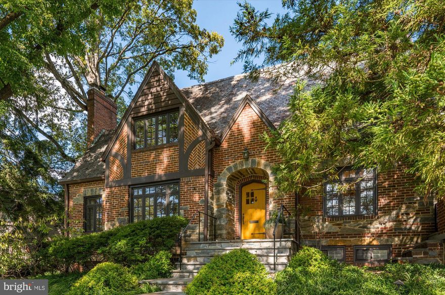 Nestled within the prestigious enclave of Country Club Hills, where timeless elegance meets modern luxury, stands a magnificent home of distinction. Welcome to 3201 N. Wakefield St, an exquisite residence built in 1935 and meticulously renovated with modern sophistication in mind.  A true masterpiece, it showcases all the hallmarks of its timeless Tudor design, including decorative half-timber beams, an intricate brick and stone-patterned exterior, lattice windows, and charming arched doorways that evoke an air of timeless refinement.  It stands proudly on a generous .40 acre corner lot, graced with a lush canvas of manicured lawns and mature trees, setting the stage for a truly enchanting living experience. 

Step inside its gracious foyer, and you'll discover a harmonious blend of formal and casual living spaces. The formal living room with a wood-burning fireplace exudes refinement and sophistication, while the formal dining room on its opposite side is an elegant canvas for memorable gatherings.  

Adorned with soapstone counters, dual sinks (including a prep sink), and Viking commercial appliances, the open-concept kitchen is a chef's dream. A captivating arched window frames views of the garden, and a spacious island with built-ins invites both culinary creativity and offers ample space for meal preparation.  A door from the kitchen opens to an outdoor patio where you can enjoy alfresco dining while overlooking the meticulously maintained lawn and majestic trees. This culinary haven includes an expansive space that accommodates a breakfast area and seamlessly opens to a family room adorned with a gas fireplace. The adjacent library study and all-season sunroom provide tranquil retreats, each opening to a separate outdoor patio, blurring the lines between indoor and outdoor living. 

Upstairs, a beautiful sitting area graces the landing outside the primary bedroom suite. The primary bedroom is a true masterpiece, featuring French doors, a bay window with built-in seating, and an impressive half-moon accent window at ceiling height, bathing the room in natural light, and providing enchanting views of the outdoors. The primary suite also boasts a walk-in closet, a spa-like bathroom with dual vanity sinks, and a standing shower that offers views of the outside garden through a window protected by a frosted glass door.  This level holds three additional bedrooms including an en-suite, and a full bathroom.

Descending to the lower level, a generously sized recreation room with a wet bar and a gas fireplace awaits, providing an ideal space for entertainment and relaxation. Additionally, you will find a half bathroom, a well-appointed laundry room, utilities and convenient access to a private 2-car garage.
3201 N. Wakefield St is more than a residence; it's a testament to the artistry of design, where timeless Tudor elegance meets contemporary luxury, resulting in a residence that is truly exceptional in every sense. Welcome to a life of unparalleled refinement and comfort in the heart of Country Club Hills!