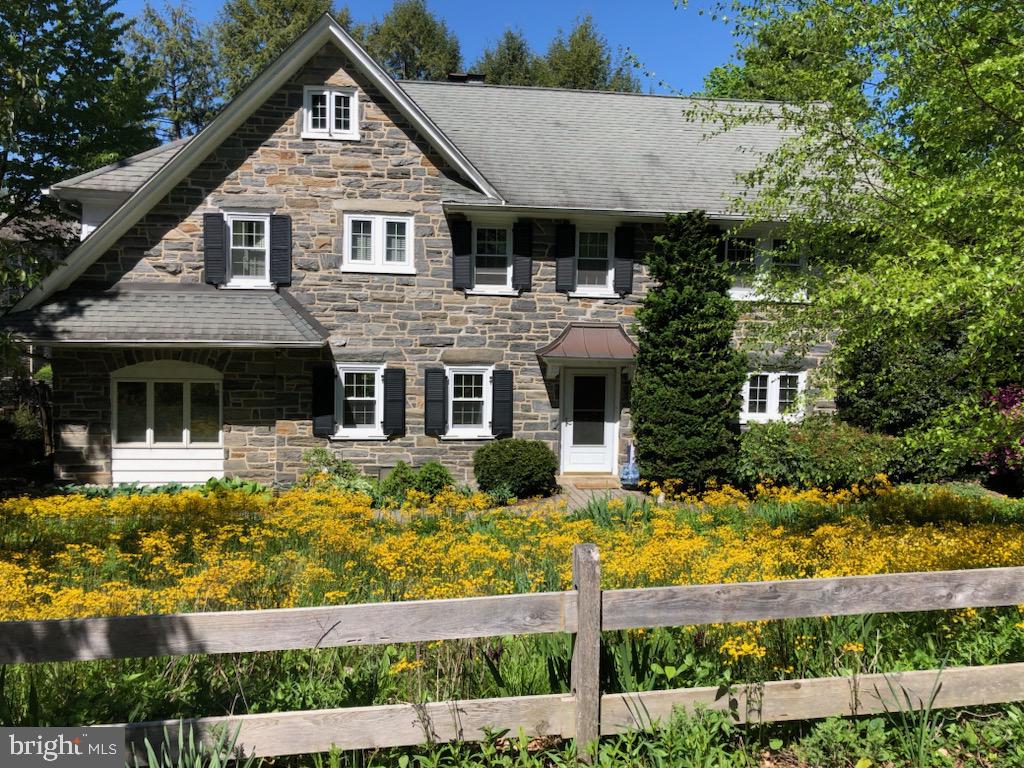 116 Saint George's Road, Ardmore. A classic, all stone, center hall colonial in the Arts&Crafts style, with five bedrooms and two and one half baths, in Northside Ardmore's most popular, walk-to neighborhood. Here, elegant 1920's era houses are set among beautiful, wide, quiet streets with mature, leafy trees and shaded sidewalks. This property includes a detached two car garage accessed at the rear, by a common driveway that used to be known as Anderson Drive. Minutes away, on foot, are all of Ardmore's charms and amenities, including Suburban Square, SEPTA/AMTRAK, LMHS's campus, Trader Joe's and then Wynnewood with Whole Foods and the Wynnewood Shopping Centers, Starbuck's, First Watch Cafe, and all of Narberth.
Enter to the center entrance hall, with hardwood floors, coat closet, and transverse stair with bright, daylight window and view at the back. Front-to-back living room has brick hearth with gas fireplace and pretty bright windows. Living room opens gracefully to step down family room, with beautiful bright windows and double atrium doors out to massive stone steps down to the rear yard. Formal dining room has beautiful, built-in arts and crafts style china cabinets, recessed statement lighting and scale. Dining room flows into updated, eat-in cherry kitchen, with granite tops, large island with second sink and seating. Gourmet cook's stainless steel appliance package. Back door opens to big, rear deck for outdoor living and steps down to private, fully-fenced for dog-lovers, with enclosed rear yard and footpath to the garage. Powder room.
Second floor landing leads to large and bright owners' bedroom with double w/i closet and updated, en suite bathroom. Three family bedrooms, all with hardwood floors, closets and pretty windows, share a second, updated full hall bathroom. The laundry room on this floor was converted from what was a third full bathroom. One could relocate the laundry to the lower level, and add a third bathroom back into the floorplan. Steps up to third floor to landing with large attic storage closets and hall to 5th bedroom.
Kitchen steps down to lower level. This is level unfinished, with storage, workroom and mechanicals. The front garden is a perenial pollinator and ecologically friendly garden, with mostly native PA species plantings.