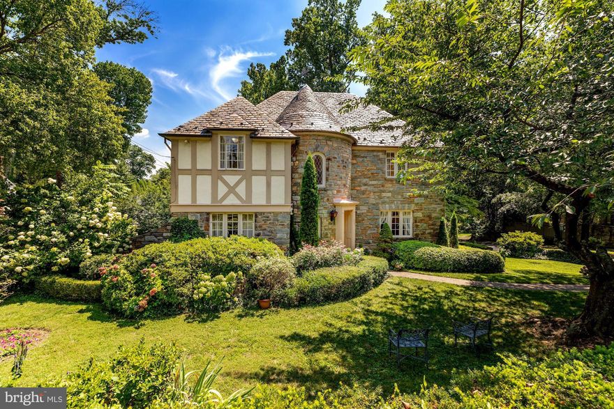 Welcome to this beautiful Normandy-style Tudor, reminiscent of the French countryside and surrounded by over a third of an acre of manicured gardens with room for a pool.  Built in 1935, this home has an abundance of interesting architectural details including three working fireplaces and two circular staircases.  Sunny first floor has great flow and opens to a rear sunroom with windows on two sides, large kitchen with access to beautiful slate patio, breakfast room, dining room, living room, library, powder room and wood floors throughout first level.   Second floor has 4 bedrooms, 2 full baths and dressing room off master bedroom with access to two balconies. Third floor has playroom/storage/overflow sleeping.  Lower level has a family room/artist showroom, studio, bedroom, full bath and laundry room.  Central vac system.
