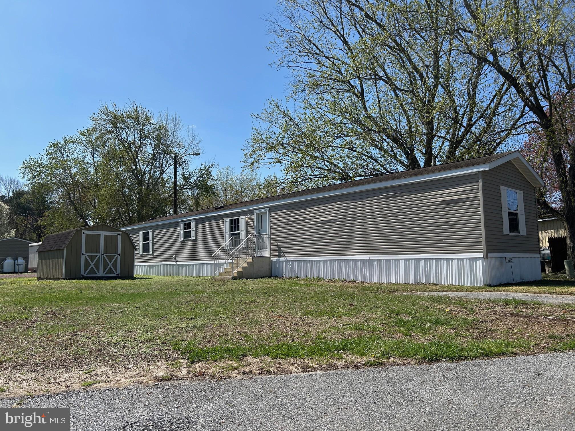This manufactured home has three bedrooms and two bathrooms. A split bedroom floor plan is separated by an open living room and kitchen/dining combo. Just past the laundry and utility area is the largest of three bedrooms with a full bathroom and walk-in closet. Two bedrooms and a second bathroom are found at the other end of the home. It has been freshly painted throughout, with new flooring, new toilets, and new shower tubs installed. Shed is included and sold As-Is. Buyers must be approved by Park Management. Ground rent includes Water, Sewer, Trash and Taxes.