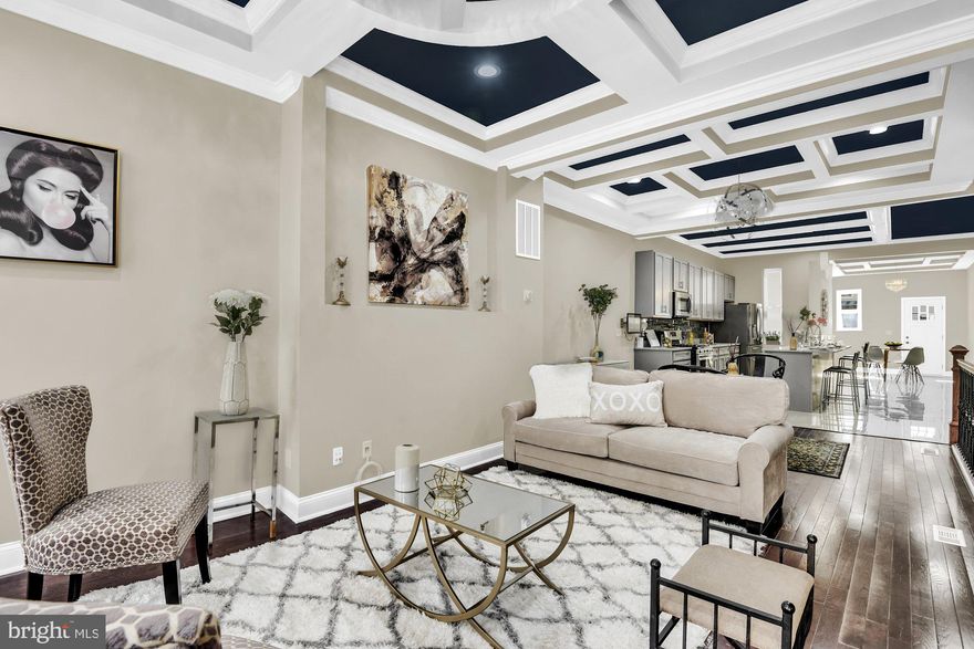 MAY qualify for 10K Vacant's to Value Booster Grant available! and  10 year CHAP tax credit! Buyer to verify all available programs.!!!...Welcome to the "New Druid Hill"...Luxury living awaits you in the historic "heart of town"...This neighborhood has so much rich heritage, and history as well as numerous architectural designs. This contemporary townhome is custom designed and delightfully crafted with class. Walk in and be "wowed" at every glance. The open floor plan boast tons of natural light that beams off of the uniqueness of the coffered ceilings. The  house is wired for multimedia voice and data capabilities . There are ceiling speakers throughout the entire house and surveillance cameras well...when connected to the internet can be viewed from any digital device on or off premises.. The hardwood flooring throughout maintains the character of the original design. The kitchen is designed for the chef of the house with custom cabinets, stainless steel appliances and an island designed for fun and entertaining. The rear yard has a privacy fence and room for parking..The lower level has a conversation area or family room  with a full bedroom and full bath and laundry area. The second level has 2 full bedrooms with a full bath and the third level has 2 master suits with a full bath in each. There is a walkout patio that over looks the Druid Hill neighborhood. This location is accessible to downtown, the Marc train, and other public transportation. This property may be eligible for Vacant to Value, and other Baltimore City incentives. It is the buyers responsibility to verify. This is NEW City living in Baltimore. Check out the matter port 3d tour...Don't miss out!!!!