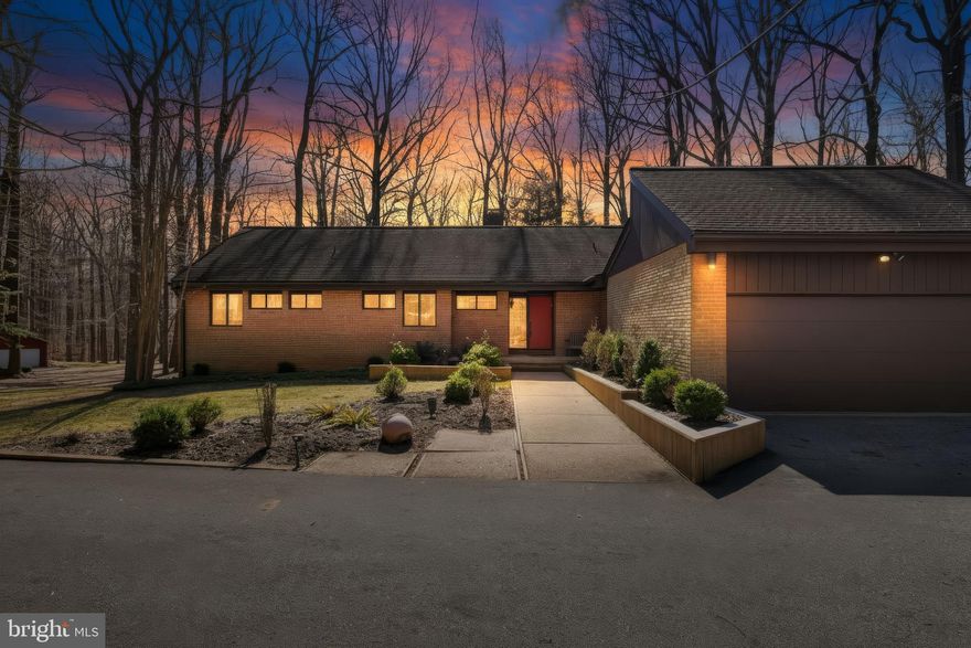 Welcome to 4 Chellis Ct, a beautifully maintained 4-bedroom, 3.5-bath home tucked away on a quiet cul-de-sac in Owings Mills. With two spacious levels, thoughtful updates, and a private wooded backdrop, this home offers both comfort and versatility.

The kitchen blends comfort and convenience, featuring granite countertops, sleek appliances, and double wall ovens, offering both style and functionality for everyday cooking and entertaining. Just off the kitchen is a bright breakfast nook with a sliding glass door leading directly to the outdoor space, creating the perfect spot for morning coffee or casual meals.

From the kitchen, the layout flows naturally into the dining area, filled with natural light, to create an inviting space for gatherings and shared meals. The dining area opens into a vast, bright, and airy living room with vaulted cathedral ceilings, enhancing the open feel of the main living space.

At the center of it all is a striking brick, wood-burning fireplace designed as a walk-around pillar, serving as the architectural centerpiece of the home. The living room wraps around this unique feature and leads into the family room, where a second sliding glass door opens to a large deck overlooking the yard and surrounding trees—perfect for relaxing, entertaining, and enjoying the peaceful outdoor setting.

The three bedrooms are conveniently located on the main level. The primary suite offers a private retreat with a recently updated attached bathroom featuring dual vanities and a walk-in shower. Two additional bedrooms provide comfortable and flexible living space, ideal for guests, family, or a home office. For added convenience, the laundry room is also located on the main floor, making everyday living easier. The level is completed by an additional full bathroom and a half bath, thoughtfully placed to serve both the bedrooms and common living areas.

The lower level adds exceptional flexibility with a bright, spacious recreation room perfect for entertaining, hobbies, or movie nights. A second kitchen/kitchenette with a mini fridge creates the perfect setup for guests or extended living arrangements. This level also includes a fourth bedroom, a bonus room that could serve as an office or additional bedroom, and a full bath with a walk-in shower.

Step outside to enjoy multiple outdoor living spaces, including a large deck that spans the entire length of the home, with multiple access points from the main level. The deck creates a covered patio area below, offering comfortable outdoor spaces ideal for relaxing or entertaining. The spacious backyard backs to mature trees, providing a peaceful setting and added privacy.

An attached two-car garage provides additional storage along with the everyday convenience and security of covered parking.
With its unique architectural fireplace centerpiece, vaulted ceilings, new carpet throughout, and flexible living spaces, 4 Chellis Ct offers the perfect blend of character, comfort, and functionality.