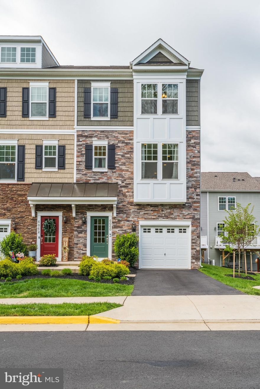 Stunning like new modern end-unit townhome in a very desirable location. This 3 level house boasts 9 ft ceilings, plenty of windows and natural light! It is situated just beside the playground and has plenty of parking spaces in front and on the side.  Enjoy the open floor plan on the main level, with a huge, gourmet kitchen complete with 10 foot quartz countertop island and stainless steel appliances, and yes double ovens! The dining area has amazing views of the woods and mountains, and just off the family room, walk out to a large deck to enjoy grilling and al fresco dining with the views of the mountains as well. Spacious owner’s suite with walk in closet and bathroom with double vanity. Just outside on the hallway is a bedroom level laundry and 2 more bedrooms and 1 full bath. The entry level has an extra room with full bath that can be converted into a bedroom, office or play area! The house also has a Culligan water softener as well as an under sink water filtration system. The garage has custom built shelves that provide more than enough storage options.  Perfect location in a quiet and quaint town of Haymarket! Conveniently located near shopping centers and dining with easy access to commuter routes.  This home is for you so grab it!