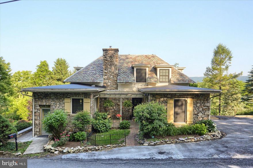 Nestled in the quiet community of Hillside located in Dauphin is this captivating 1912 stone Cape Cod home. This historic enclave was once known for its summer cottages. This  home offers timeless character and tranquil living on 1.53 scenic acres. With 2,344 square feet of inviting interior space, the home features warm hardwood floors, beautiful stone fireplace, exposed wood ceilings and a large screened-in porch that overlooks the backyard. The  open floor plan offers a living room/dining room combination or use the bright sunroom as you dining area.  Two bedrooms on the first floor with full bath and two bedrooms on the upper level with an updated full bath. This home offers a perfect harmony of indoor and outdoor living and invites natural light and breezes throughout. One-car integral garage with additional parking on the other side of the home.  Whether you're sipping coffee on the porch, hosting guests in the warm, open living spaces, or simply enjoying the peaceful setting above the river,  this unique property is a rare blend of history, comfort and beauty! Here is your opportunity to own a home that feels away from home!                             *****OPEN HOUSE, SUNDAY JUNE 8TH. 1-3PM*****