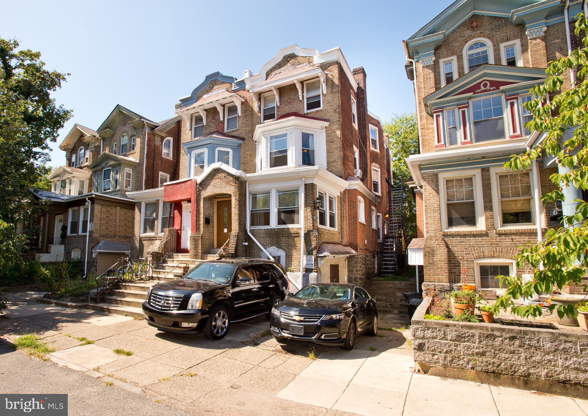 Zoned RM1 - Multi Family, Day Care, Religious Assembly -   Large Victorian Twin in Spruce Hill Section of Philadelphia, Close to Penn and Drexel with Driveway PARKING. The Home is currently configured as a 3 Bedroom 2 Full Bath residence on the first two Levels and a separate 2 Bedroom Apartment on the 3rd Floor. (with Exterior Stairs for Entry) Could easily be turned into a Large 5 Bedroom Single Home or restored back to a triplex with 1 Unit per Floor. Main Level Features Original Hardwood Parquet Flooring, Brick Wood-Burning Fireplace, and Recessed Lighting. Large Living and Dining Rooms plus Sun room, Full Bath and Updated Kitchen Leading to Sitting Room and Outdoor Deck. Upstairs features Master Bedroom with Full Bathroom and Whirlpool Tub, 2 Additional Bedrooms, Full Hall Bath and Stairs to 3rd Floor (Presently Blocked Off) Third Floor Apartment was recently rented for $900 a month. 2 Bedrooms 1 Full Bath Kitchen and Dining/Living Room. In need of cosmetic Upgrades. A great opportunity to purchase a Large Home with Parking in Booming UPenn area of Philadelphia.