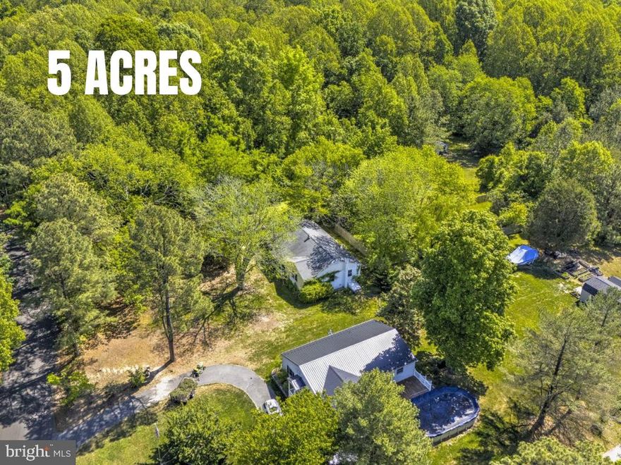 Rambler on nearly 5 private acres - bring your vision! Discover the ease of one-level living nestled in the heart of Mechanicsville. Offering 4 bedrooms and 2 bathrooms, this property provides plenty of space both inside and out. Enjoy the peace and privacy of the expansive lot, where you can relax, listen to the birds, and truly unwind. Detached garage included for additional storage, hobbies, or workshop space. Conveniently located near local parks, shopping, and commuter routes, this home offers the perfect mix of rural charm and everyday convenience.  This property is ready for your vision and presents an excellent opportunity to build instant equity. With some updates and improvements, the potential here is incredible. Whether you're looking for room to spread out, create your dream homestead, or simply enjoy peaceful country living, this property offers endless possibilities. Photos have been staged by AI.