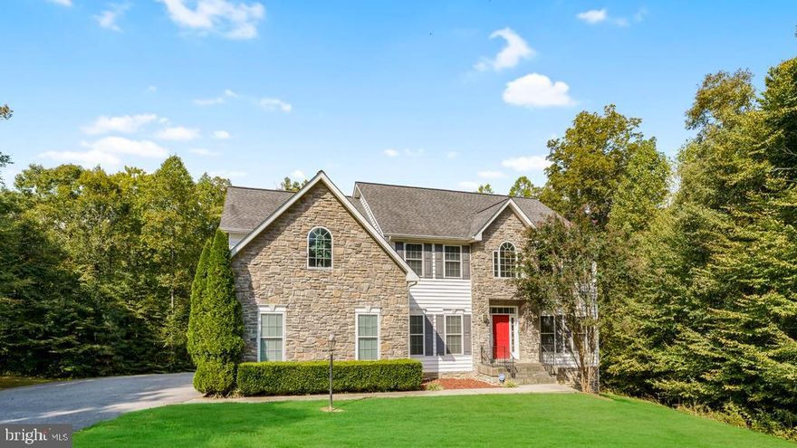 *Just Reduced $10,000 and Seller will give $5,000 carpet allowance*  Beautiful Stone-front Colonial in sought after Gated Community of Worman Estates. Country living at its best. Located 20 minutes to downtown Fredericksburg and Dahlgren Naval Base. Nestled on 10.5+ sprawling acres giving you the space and privacy you desire. Home boasts of three finished levels with custom features to provide space, comfort, and enjoyable living. Two-Story Family Room accentuates the wall -to-ceiling stone fireplace on the main level. Additional fireplace in the massive Master bedroom with spacious sitting area. Huge Kitchen features center island with ceramic cooktop and huge pantry . Main level Office can be used for an additional Bedroom. Formal Dining Room and Living Room. Huge Trek Deck off the Kitchen overlooks acres of private secluded lot. Lower level Basement features a Movie Room, Gym, Guest Bedroom and full bath, Laundry Room, and Entertaining/Great Room. Come see your New Home.