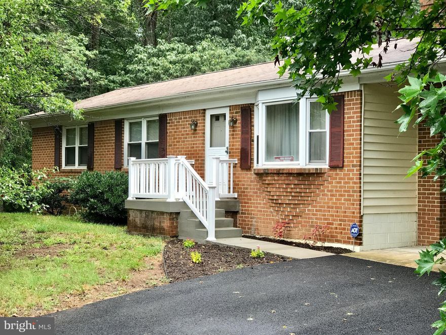 4BR/2.5BA rambler w/carport & full basement. Finishing touches include new driveway, new concrete front steps/walkway!  Pergo floors in LR, large country kitchen w/french doors to deck. Serene yard backing to woods. Newly refinished family room has wood stove insert & sliding glass door w/ walkout to yard. Updated half bath in basement. Convenient to NAS Pax River, Andrews & DC.