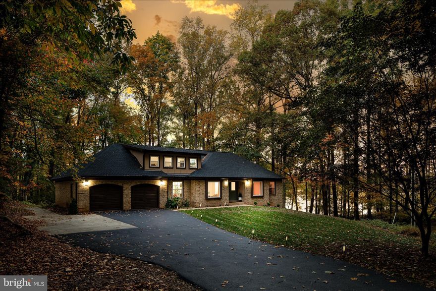 Stunning, completely renovated all-brick ranch home with a large loft and fully finished walkout basement, offering luxurious living in a serene lakeside setting. Nestled at the end of a quiet cul-de-sac, this home is surrounded by woods and boasts lake views on two sides. Inside, the open floor plan is highlighted by luxury vinyl plank flooring, high-end finishes, and large windows in every room that frame the sweeping lake views. The gourmet kitchen features custom cabinets, leathered granite countertops and backsplash, and stainless steel appliances. All bathrooms have been beautifully remodeled with custom tile flooring, designer vanities, and modern fixtures. The backyard is equally impressive, with a large deck perfect for entertaining or relaxing, a backyard fire pit overlooking the lake, and direct access to a scenic lakeside trail. Enjoy fishing, kayaking, or canoeing just steps from your yard.
Tucked away in the woods for privacy, yet ideally located on the Gainesville side of Warrenton, this home offers easy access to shopping, dining, transportation, and local wineries. This is lakeside living at its finest!