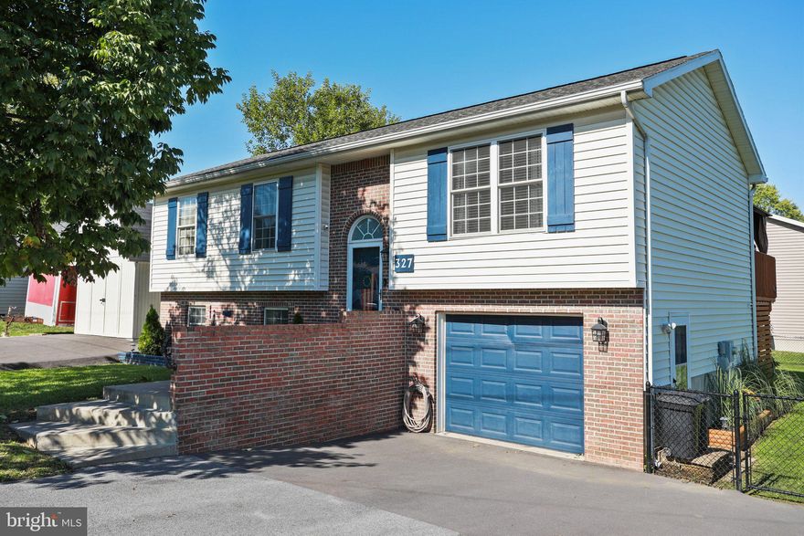 Stylish & move in ready! 2 bedrooms and 2 full baths on upper level and lower level has it's own full bath, living area and 3rd bedroom! Home is currently used as a multigenerational home! Kitchen, living and dining areas are semi-open, warm and inviting! Kitchen is complete with stainless steel appliances, quartz countertops and island. New LVP flooring in some parts of home. Upper level, primary bedroom with attached full bath and walk in closet and barn door.  Sliding glass door off of dining area opens to an upper deck! The level and fenced rear yard is sure to please! Stacked rear deck and patio area with hot tub and awning! Attached 1 car garage with inside access and storage! Detached  12 x 24 shed/ garage with double front door and rear single door. 2 driveways for plenty of off street parking!