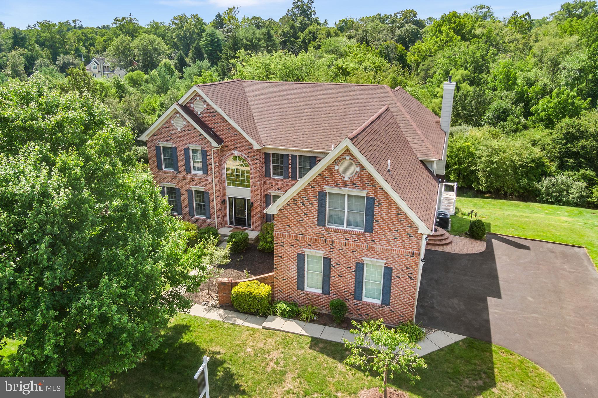 Welcome to 19 Strickland Way, in Glen Mills. This stunning 4 bedroom, 3.5 bathroom Brick and Hardi Siding home located in the beautiful community of Tall Trees at Thornburg is guaranteed to impress! As you enter the dramatic 2-story, circular foyer, you are able to take in the open-concept living space which awaits you. Natural light floods into this home through the many large windows creating a great accent for the beautiful hardwood flooring on the main level and the gorgeous winding staircase to the upper level. To the right is a very spacious, private office with a wonderful view of the front yard. To the left is a spacious entertaining/flex room which flows into the large dining room with corner windows which look out over the private natural backdrop. The dining room opens to the kitchen which offers recessed lighting, stainless steel appliances, custom tile backsplash, granite countertops, a center island/bar, pantry and casual dining area. Completing the Great Room is the spectacular family room with a floor-to-ceiling stone-accented gas fireplace and vaulted ceilings with recessed lighting all set off by the beautiful elevated palladium windows and French doors which offer an amazing view of the bucolic setting, welcoming the outdoors inside. French doors both in the kitchen and family room lead out to a semi-circular, maintenance free deck which spans across a significant portion of the back of the house and overlooks the rear yard. A laundry room, half bath and entrance to the oversized 3-car garage completes the main level. On the upper level you will find an expansive primary bedroom with a dramatic tray ceiling, 2 walk-in closets and a large ensuite bathroom with 2 separate sink areas, soaking tub and shower. In addition, there are 3 more generously-sized bedrooms, one of which has an ensuite bathroom, plus a full Jack-and-Jill bathroom in the hall. The expansive, fully-finished lower-level boasts 12' ceilings, recessed lighting, hardwood flooring, carpeted workout area, ample storage space, and access to the back yard. No worries about stucco here....all stucco was remediated in 2010 and replaced with Hardi Cement siding. In addition, all doors and windows were replaced at that time. Other recent improvements include a new roof in 2024! Located in the highly-acclaimed West Chester Area School District, this home is conveniently located to shopping, restaurants, entertainment and more. Easy access to all major highway connections including Routes 1 & 3, and just minutes to Cheney University. Tall Trees at Thornbury community offers walking trails for use by its residents. Style, sophistication, and so much more! This is an amazing home in a fabulous community. Book your showing today!