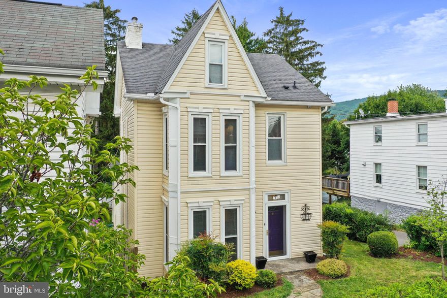 A very rare find in quaint Smithsburg, Maryland. This lovely home exudes historical charm and tranquility.  A corner lot and set back off the road, the home has lovely front, side, and back garden spaces.  Stunning mature trees and truly a park-like feel, low maintenance landscaping, shed, off-street parking, privacy fencing, stone patio and walkways, and more. From the moment you step into the foyer on the gleaming hardwood floors you will feel how special this home truly is.  The home has a rich history and is mentioned in the publication Walking Tour Town of Smithsburg. The age is recorded as 1900 but records date it back to possibly 1829.  The home has been upgraded to all electric heat and air conditioning with a half bath on the main level and a full, custom bath with walk-in tiled shower on the second floor. There are three bedrooms with the third being on the uppermost floor and having a lovely sitting area and rustic wood plank flooring. The true pine paneled family room could be a home office, guest suite, artists retreat, playroom, craft room, or whatever your lifestyle commands. There are exposed original brick walls throughout the house and the home is all brick. The basement is accessed from this room or via the outside entrance. This level is neat as a pin and features a large "decorative" fireplace, laundry, and large storage/workshop space. This home offers so much more; plan your visit to see if this home is right for you!