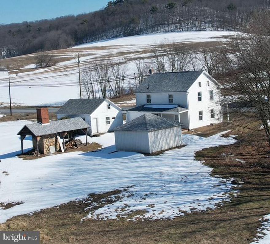 Only approximately 20 minutes from the beautiful Jim Thorpe area, this charming circa 1878 stone farmhouse sits on 7.3 Acres. It boasts 2ft deep windowsills.  The stone was exposed in the kitchen to showcase what's under the siding. The opportunities are endless. With it's mixed-use zoning, there are business options (verify with township). 3 Bedroom home with an additional guest house attached. 2 car carport/garage.  Brand new roof and most windows are vinyl replacement. Enjoy views of mountain chains on either side of this home from covered front and rear porches and a quaint shanty with outdoor fireplace. The 7 + acres include a stream, your very own pond and plenty of tillable flat fields. Just 2 miles from 309 and 10 minutes from the PA turnpike for quick access. Property needs work