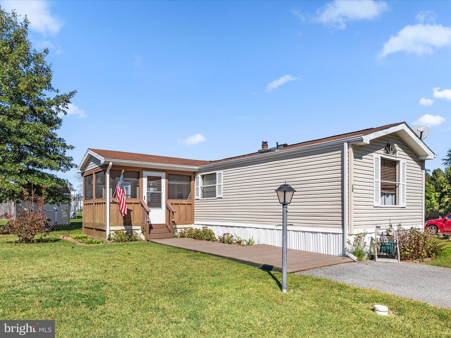Wonderfully maintained home in the quiet community of Hub Court East, convenient to restaurants, grocery stores, medical offices and anything you could need! This 2 bedroom 2 full bath home sits quaintly at the end of a cul de sac with very little traffic, and a wooded treeline. A rarity in singlewides, this home offers a foyer, complete with a built-in cabinet and countertop for keys and mail. The bedrooms are arranged in a split floorplan, allowing privacy between the rooms and open living space in between. The vaulted ceilings give everything a feeling of spaciousness. The table space kitchen features abundant cabinetry and counter space, including pantry cabinets and a built in china cabinet. The full sized washer and dryer are conveniently tucked adjacent to the kitchen, with additional cabinetry. There's a large screened porch for entertaining and relaxing in warmer weather, and a large shed for storage of garden tools, mowers, beach toys and more. Upgrades include a newer water heater and some vinyl replacement windows. Park application required for residency. Approvals are conditioned on credit and background checks as well as verification of income and/or assets. **Pardon the temporary mess—Millsboro is upgrading the nearby sewer system, with work expected to finished by summer.