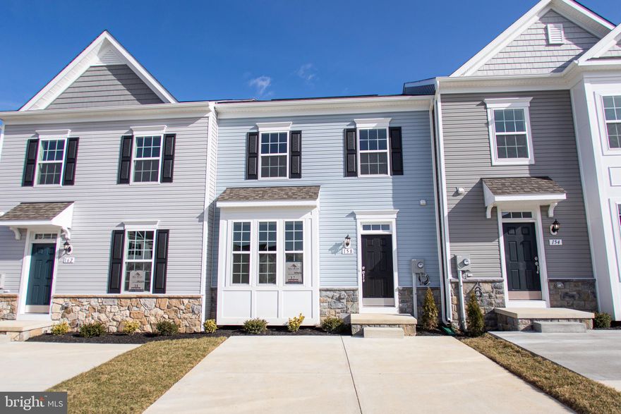 July Move-In! Lock in your price now!  Come see this beautiful, 3 level town home where you walk-in on the main level! No pesky stairs to bring your groceries up! New, wider floor plan featuring hardwood in the kitchen and family room. Upgraded kitchen with island and upgraded cabinets. Partially finished lower level rec room. Maintenance free yard covered by HOA! Must see community! Don't miss out!