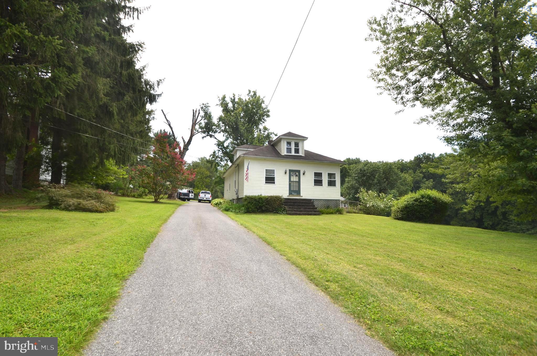 Not a drive by!! Must see inside!! This cottage boasts 3 Beds / 2 Full Baths and a nice cozy interior + a rear covered deck with built in seating overlooking the expansive rear yard. The exterior needs a a bath + a little TLC to make it shine. Interior is very nice and super well kept for the age of this home. The main level has oil heat and hot water + 2 window A/C Units. The upper level has a heat pump that supplies central heat and A/C. The owner was a carpenter by trade and it shows. The home was updated and fixed up several years back and is still in great shape. The lot is a very nice LARGE and FLAT lot!! Backs to open space and is very spacious. This one is priced to sell fast and will be someones dream come true right near Liberty Lake. A conventional loan will be best. AS-IS CONDITION.