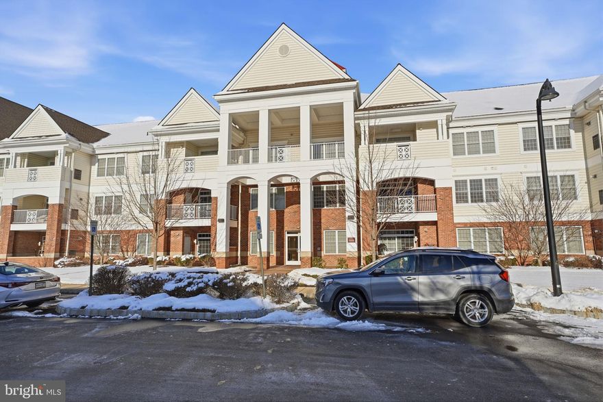 Welcome to this exquisite 2-bedroom, 2-bathroom residence in one of the newest buildings at the highly sought-after Meridian of Valley Square, a premier 55+ community in the heart of Bucks County. A welcoming foyer introduces the spacious, light-filled interior, where the open dining and living rooms showcase gleaming floors, a wet bar, a charming corner electric fireplace and sliding glass doors that open to a private balcony overlooking the beautiful courtyard. The gourmet kitchen is a chef’s delight, featuring top-of-the-line stainless steel appliances, including a gas cooktop, custom cabinetry, elegant countertops, a casual dining island with seating . The luxurious primary suite offers a tranquil retreat, a sunlit sitting area framed by a triple window, an expansive walk-in closet, and two additional closets for ample storage. The spa-inspired en suite bath is beautifully appointed with a double vanity and  soaker tub. The second bedroom, privately situated on the opposite side of the home, makes for the perfect guest suite with plenty of light and a large closet. An adjacent full bathroom and a conveniently located laundry room—complete with full-size stackable washer and dryer. This home includes a private full-size garage with interior access, as well as a nearby dedicated storage unit. The Meridian lifestyle is unparalleled, offering secure entry, elevators, walking and jogging trails, a saltwater pool, and a clubhouse with a billiard room, fitness center, library, and more. Perfectly located within walking distance to Wegmans and the shops and dining of Valley Square, with easy access to major commuting routes and just minutes from historic Doylestown Borough, this home is a rare offering in one of Bucks County’s most desirable communities.