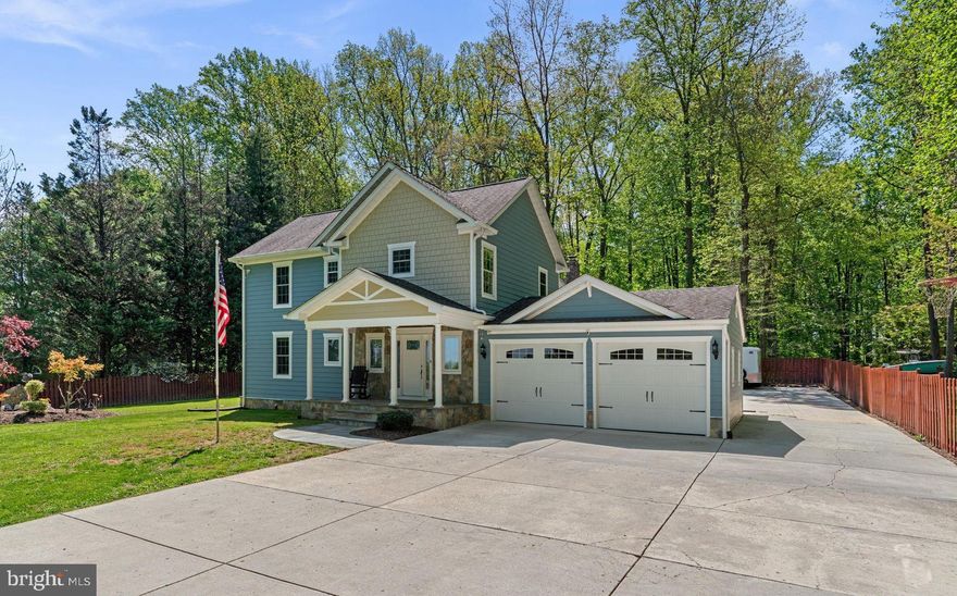 Completely renovated in 2014, this expansive two-level residence blends generous living spaces, thoughtful updates, and exceptional functionality on a private, nearly one-acre lot in sought-after Sandy Spring. With approximately 3,900 square feet, the home offers an ideal layout for everyday living and entertaining. A welcoming foyer opens to spacious dining and family rooms, accented by oak hardwood floors throughout the main level and upper level. The family room is enhanced by elegant crown molding with integrated lighting, creating a warm and inviting ambiance plus wood fireplace, while the dining room features classic chair rail detailing. Refined finishes continue throughout the home with 6-inch baseboards and 4-inch window casings. The kitchen was remodeled in 2021 with new cabinetry, granite countertops, KitchenAid appliances, a large center island, a walk-in pantry, and direct access to the back patio for easy indoor-outdoor dining and entertaining. There is also a dedicated lounge/ bar room with wet bar and custom built-ins. The main-level primary suite includes a generously sized bath, while upstairs offers three oversized bedrooms, including one with a walk-in closet and private bath making it an ideal second primary suite. All bedrooms are prepped for TV connections. A separate rear staircase leads to a huge loft/office or optional bedroom, providing valuable flexibility. A mudroom/laundry room off the oversized two-car garage connects to an additional side patio. A wraparound driveway leads to an additional detached oversized three-car garage built in 2021, along with ample extra parking for vehicles, trailers, and more—perfect for a car enthusiast. Outdoor features include surround sound to both patios, offering great spaces for relaxing or entertaining. Major updates include new Hardiplank siding, roof, and gutters in 2014; three HVAC units installed in 2010, 2014, and 2021; a 400-amp electrical panel; a new water heater and water filtration system in 2024; and a new washer and dryer in 2025. This home blends quality craftsmanship, timeless charm, and modern convenience—all in a private natural setting, just minutes from Olney’s restaurants, shopping, and everyday conveniences.