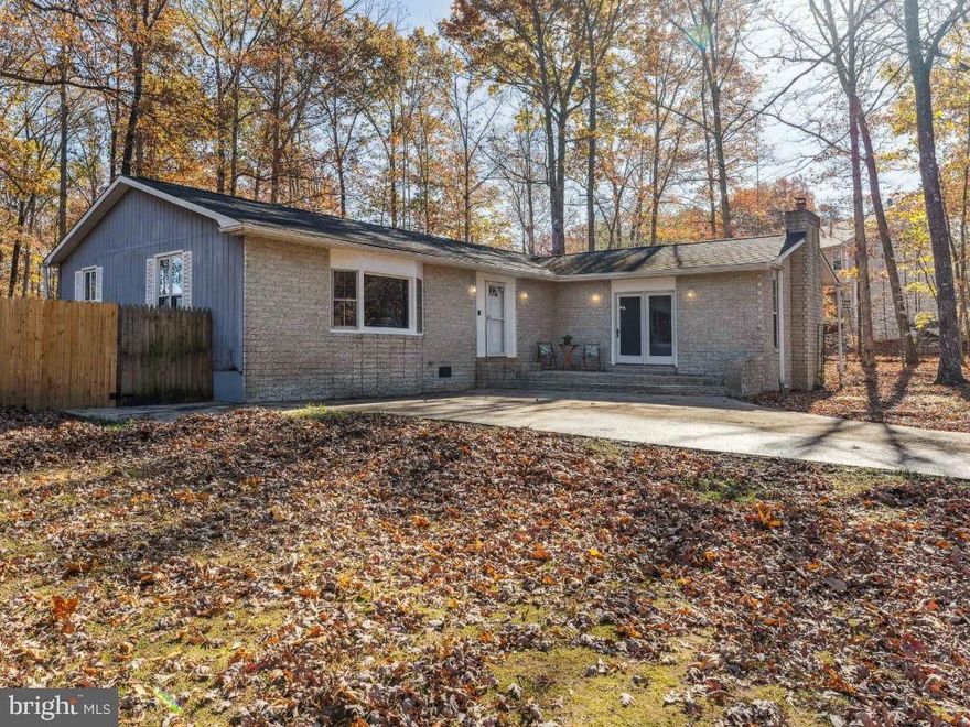 Welcome Home!  NO HOA!  MOVE IN READY!   Situated on a 1.2-acre lot, this 3-bedroom, 2 full bath modern classic rambler is 1-level living at its’ best!  With over 2,000 square feet, this renovated home features updated design details throughout!  Beautiful, upgraded flooring greets you at the front door and flows throughout the living room, dining area, eat-in kitchen, and hallways!   The generous sized eat-in kitchen boasts new white cabinetry, granite countertops, new stainless appliances and a peninsula that can be used for additional storage and counter space!  The primary en-suite bedroom is gracious in size and features a full bathroom!  The primary en-suite bathroom showcases a large walk-in shower with custom designer tile!  Both bathrooms feature upgraded vanities and contemporary lighting!  All bedrooms have ceiling fans!  Through an interior stylish barn door, you will find a great space that can be used as a family room, rec room, playroom and/or more!  Off the kitchen and through a single French door you have direct access to the backyard deck!  The flat fenced-in backyard offers privacy and is a great open space!  This home's exterior  also features a front and side yard!  The extended driveway allows for plenty of parking!  New flooring and carpet, fresh paint, new kitchen, new bathrooms and so much more!  Conveniently located near VRE, Shopping, Restaurants, Hospital Center, I-95, Route 1!  NO HOA!  MOVE IN READY!  Do not miss out!