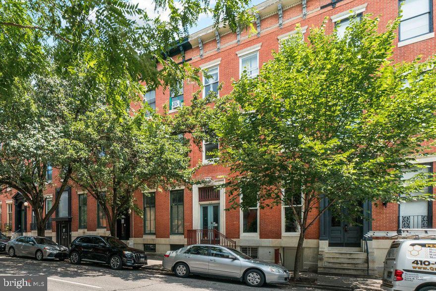 919 Saint Paul Street offers a blend of 4 unique apartments, each with its own character. In the main vestibule, a grand curved staircase and parquet hardwood floors create an impressive entrance. Each above-grade apartment is plus-sized and spans 1,406 square feet. Apartment 1 has two decorative fireplaces and picture molding throughout each room. The modernized kitchen offers all conveniences with a dishwasher, garbage disposal, easy-to-maintain laminate cabinets, and a 30″ gas range. Apartment 2 also combines historic charm with modern amenities. The kitchen includes butcher block counters, wood cabinets, a 30” electric range, dishwasher, disposal, and a built-in microwave. Apartment 3 features built-in cabinetry and one fireplace. The kitchen is equipped with butcher block counters, wood cabinets, an electric cooktop, double wall oven, dishwasher, and disposal.A newly renovated studio, accessible from the rear terrace, features walk-out access and a private patio. Fresh laminate flooring throughout, along with modern wood-shaker kitchen cabinets and new appliances, will attract tenants quickly.

All apartments have hardwood flooring, with some carpeting in the bedrooms. Apartments 1, 2, and 3 have ceramic tile flooring in the bathrooms and tubs with ceramic tile surrounds. The studio apartment includes a shower stall with a ceramic surround. Kitchens are equipped with ceramic flooring for durability. Shared, free laundry is located in the common area of the basement, which also has both finished and unfinished storage space.

Utility Specifics:
A central, gas-fired Weil McClain boiler serves the entire building with radiator distribution. Each apartment also has supplemental heating provided by in-unit heat pumps and have central air conditioning. These supplemental systems may not be in working order and are sold as-is. A gas-fired, 2019 State 73-gallon water heater serves the apartments. There are 6 electric meters and 1 gas meter. A savvy landlord could incorporate a utility bill-back into the leases and benefit from higher cash flows. Most observable water supply lines are copper; observable drain lines are PVC or steel. A gravel parking pad in the rear comfortably fits two vehicles.

What’s Great About Mount Vernon:
919 Saint Paul Street boasts an impressive “Walk Score” of 98 out of 100. Nestled in the heart of Mount Vernon, this investment property is just a few blocks away from Baltimore Penn Station. This Amtrak hub is undergoing major redevelopment, ensuring it remains a significant economic driver for the neighborhood’s continued growth and prosperity. Tenants will enjoy the vibrant cultural scene just minutes from their doorstep, with captivating performances at renowned venues such as The Lyric, Center Stage, and The Meyerhoff Symphony Hall. The area also offers an array of high-end restaurants, enriching museums, and prestigious universities, including the expanding University of Baltimore and the Maryland Institute College of Art (MICA).