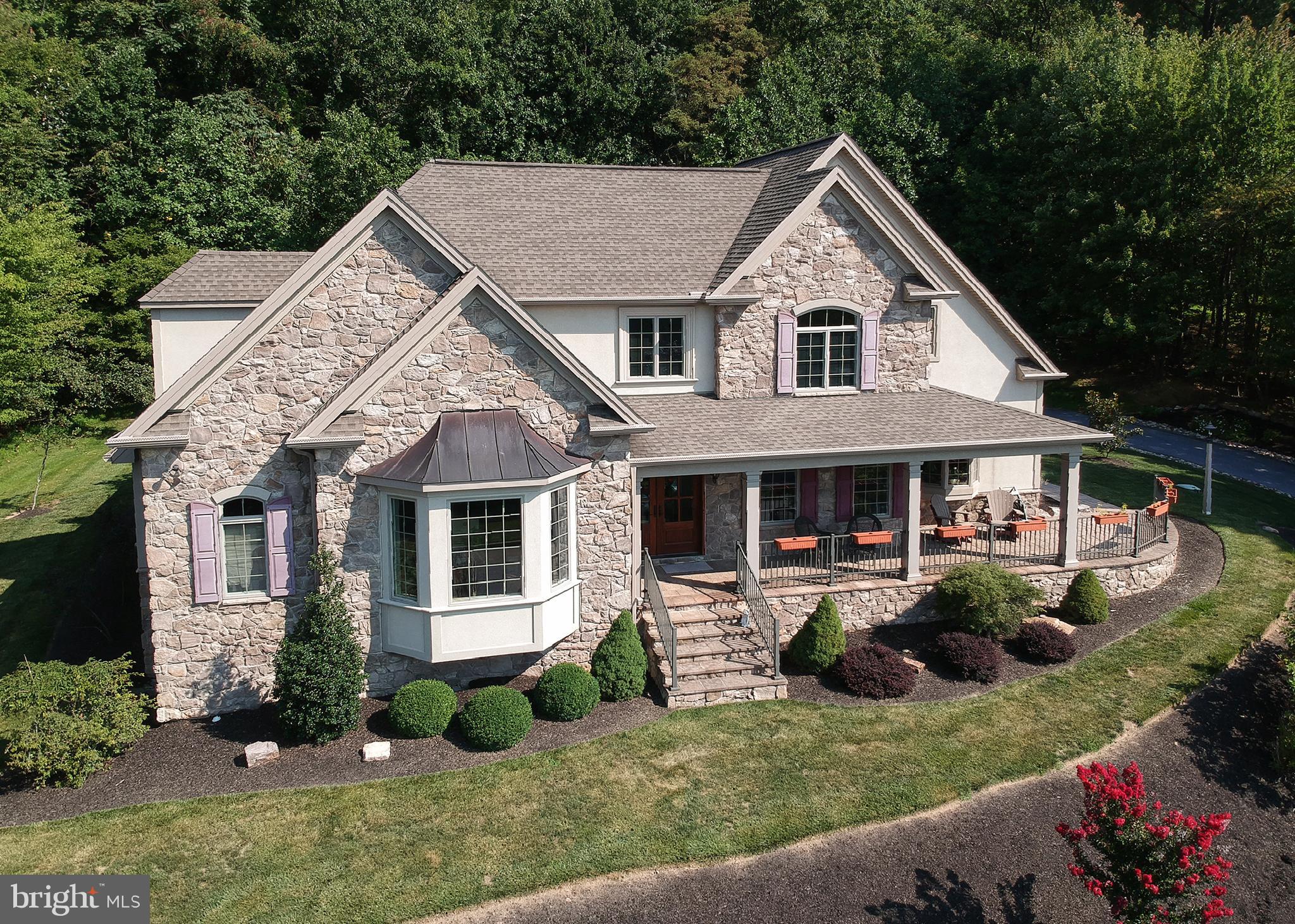 This beautiful custom home by Carricato Builders,  built  just a few years ago was featured in Parade of Homes.  Upon entering  the foyer you will immediately notice the vaulted staircase with an abundance of natural light flowing in.  Boasting nine foot ceilings, crown moldings, custom hardwood floors and lights this home will not disappoint.  Located right off the entrance is a large spacious living room or home office depending on your needs.   If you love to entertain and cook this kitchen will check every box.  The large open floor plan provides the perfect setting for entertaining a crowd.  With the holidays right around the corner you will enjoy cooking in the gourmet kitchen with a Thermador range and plenty of counter space to prep and serve.   While dinner is in the oven, enjoy cocktails by the wet bar which generously flows into the family room with a wood burning stone fireplace.  A first floor master suite with an additional gas fireplace makes the perfect setting to enjoy a cup of coffee in the morning while watching the leaves change on the mountains.  A large loft is located on the second floor that is currently being used for an exercise room could also be used for a home office or closed in for an additional fourth bedroom.  If you need additional living space the bonus room over the garage could easily be finished off.  This distinctive home was built with upgrades and amenities any home owner would love and appreciate.  Short distance from the Hospital, easy access to the highways, restaurants, and shopping.  You truly can have it all with this home.  Welcome home!